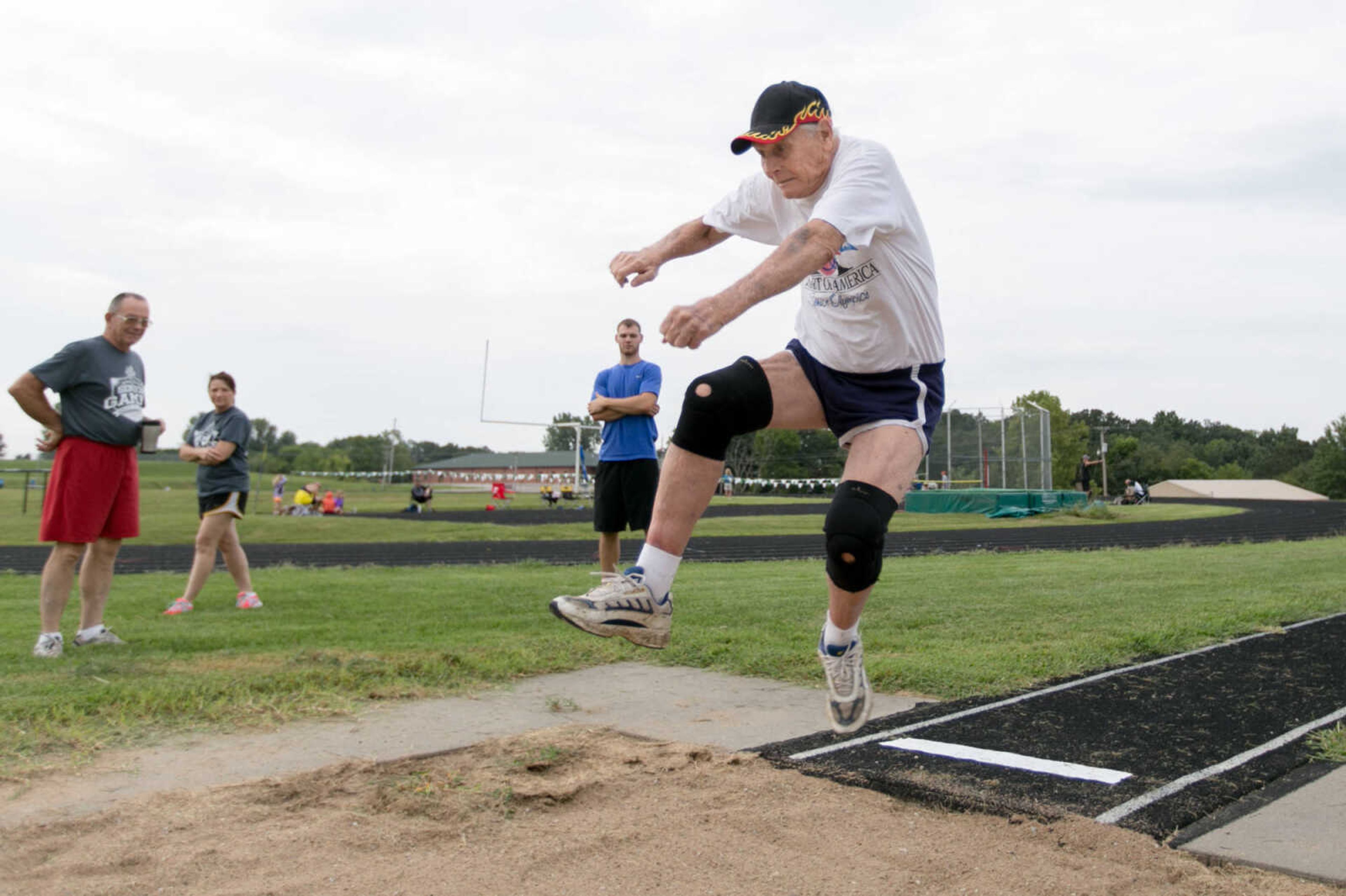 GLENN LANDBERG ~ glandberg@semissourian.com

Frank Bollinger, 87, leaps into the air during a long jump attempt at the Southeast Missouri Senior Games in Perryville, Missouri Saturday, Aug. 22, 2015.