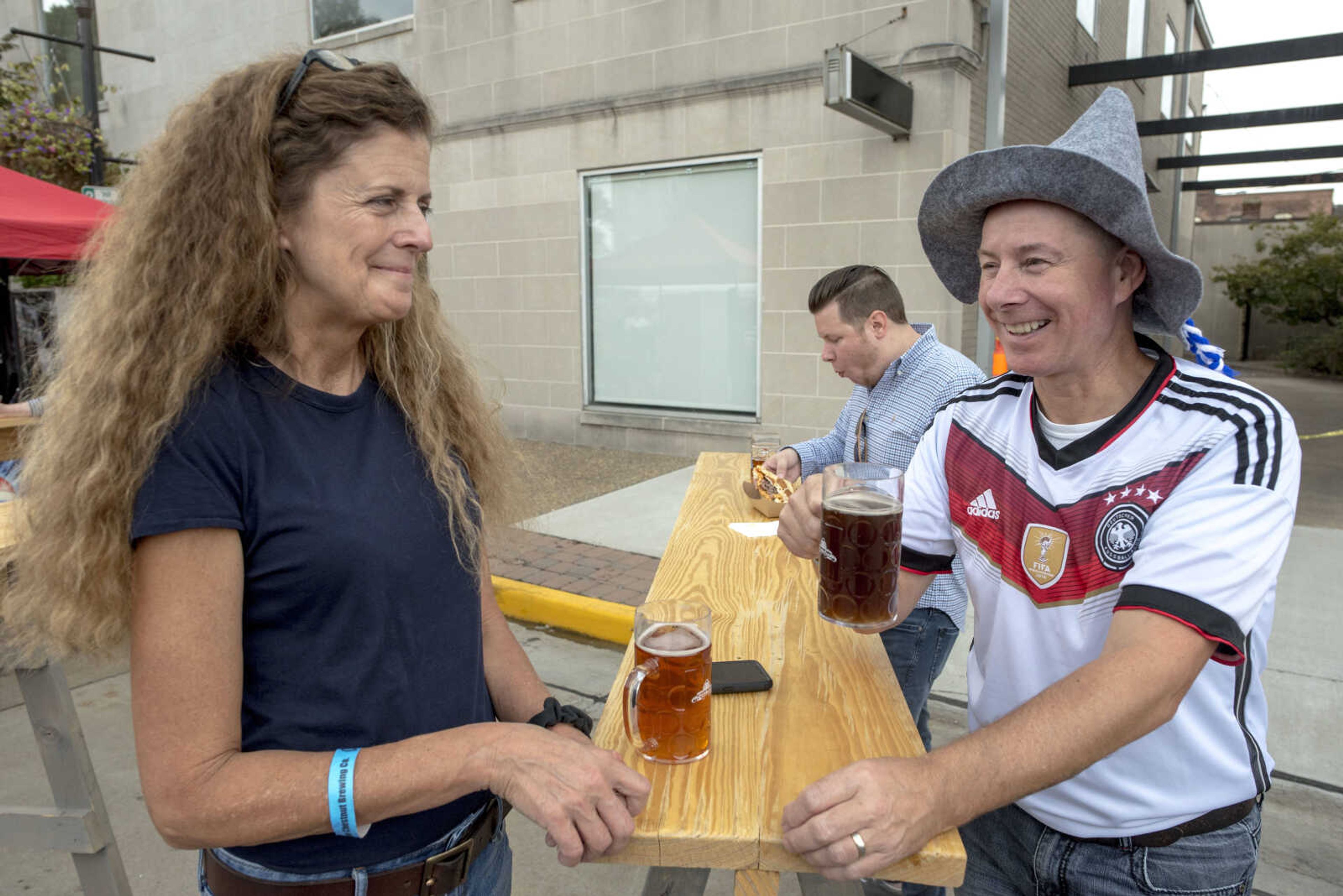 Denise and Frank Steinert enjoy conversation over beers during Uptown Jackson Oktoberfest Saturday, Oct. 5, 2019, in Uptown Jackson. Frank, who is originally from Germany,  now works at Mondi in Jackson.