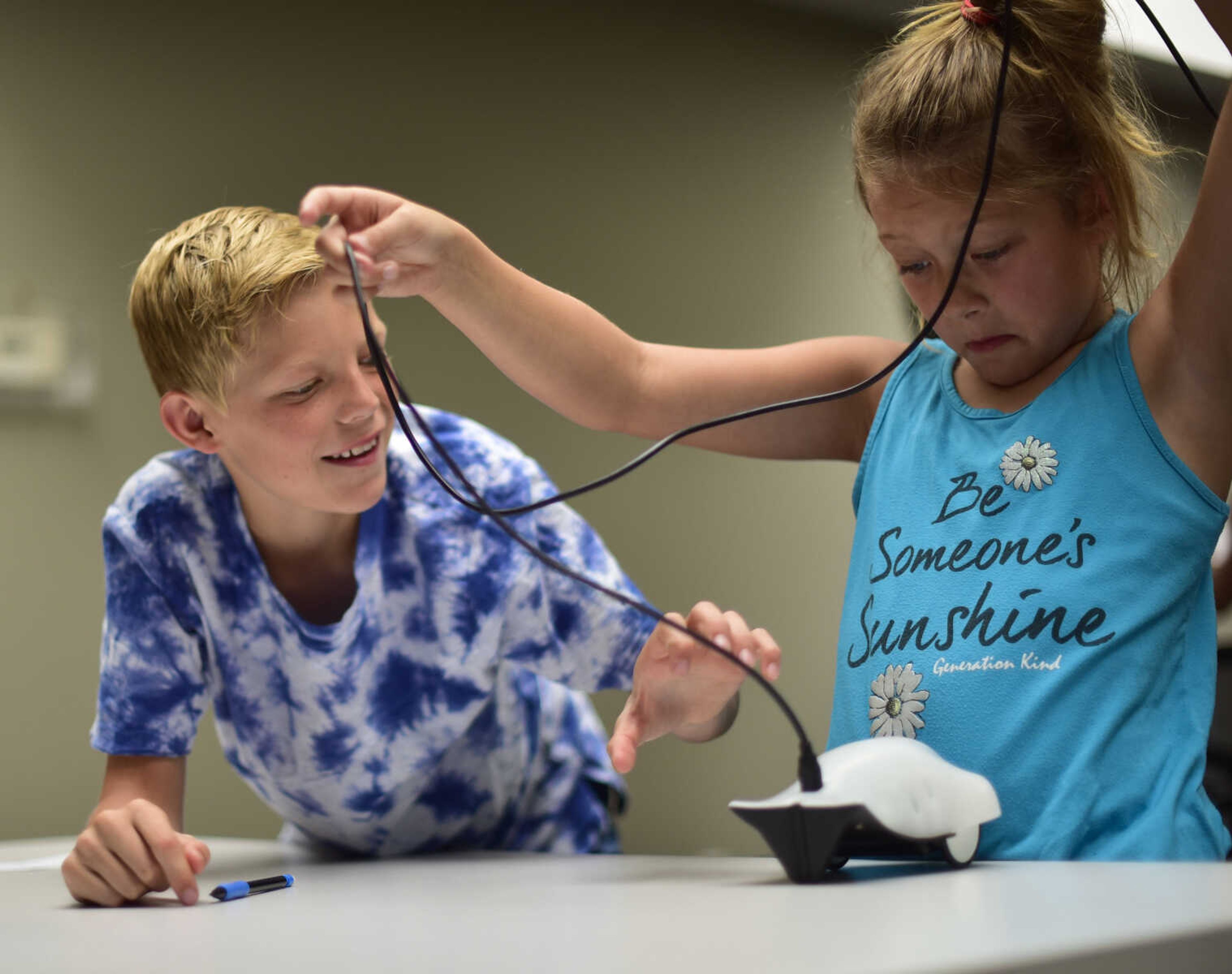 Mason Landgraf and Ava Wessell untangle their robot during the Code Camp: Coding with The Finch with the Marquette Technology Institute Monday, July 17, 2017 in Cape Girardeau.