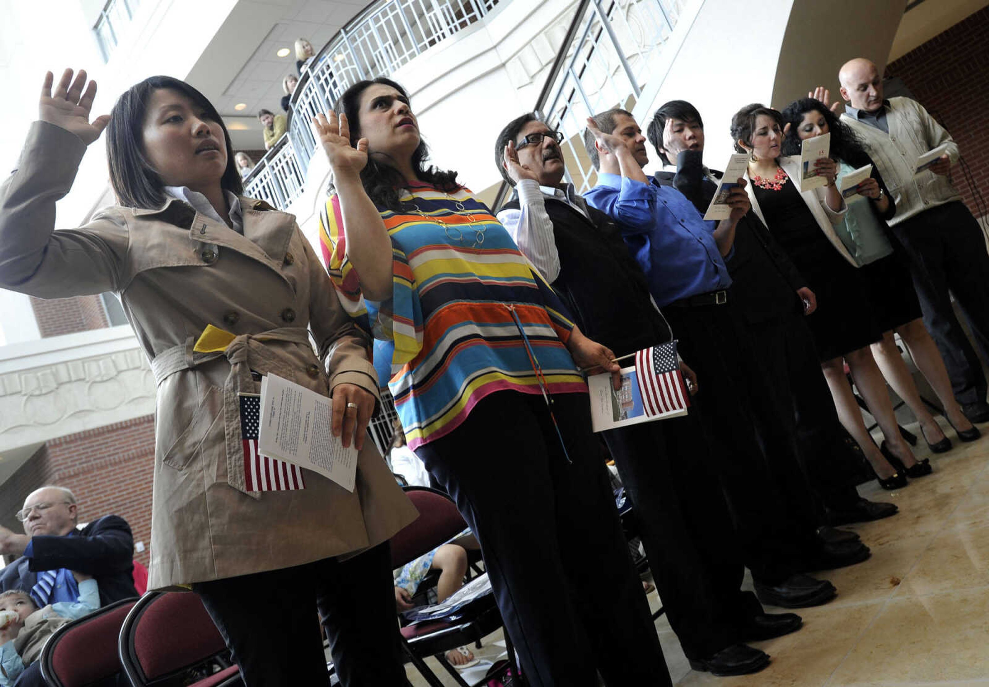 Petitioners recite the Naturalization Oath of Allegiance to the United States during a naturalization ceremony Friday, May 2, 2014 at the Rush H. Limbaugh Sr. U.S. Courthouse in Cape Girardeau.