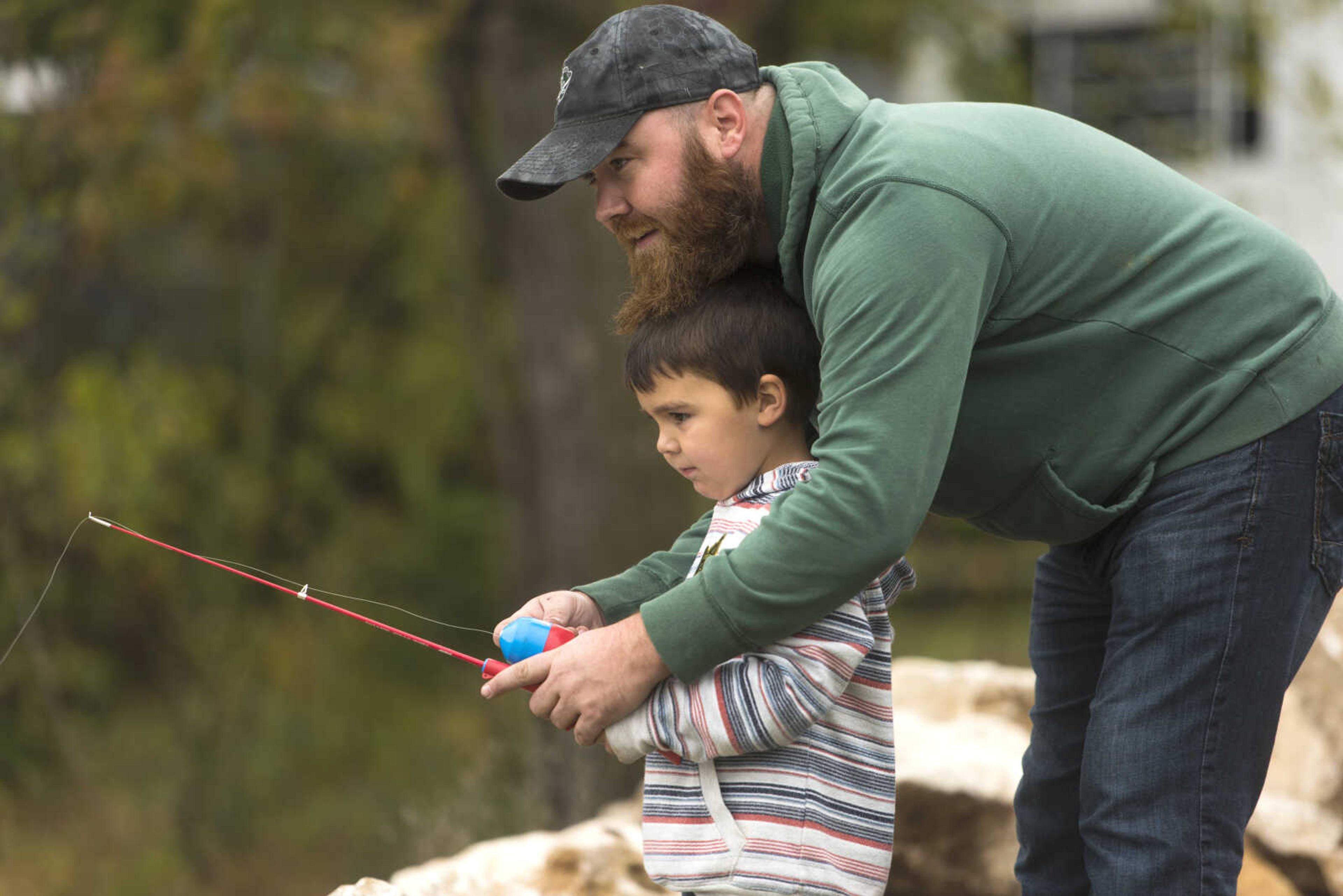 Levi Newton, 3, receives help from his father, Chris, during the inaugural Fishing Rodeo held at Oct. 12, 2017 at Elks Lake in Cape Girardeau.