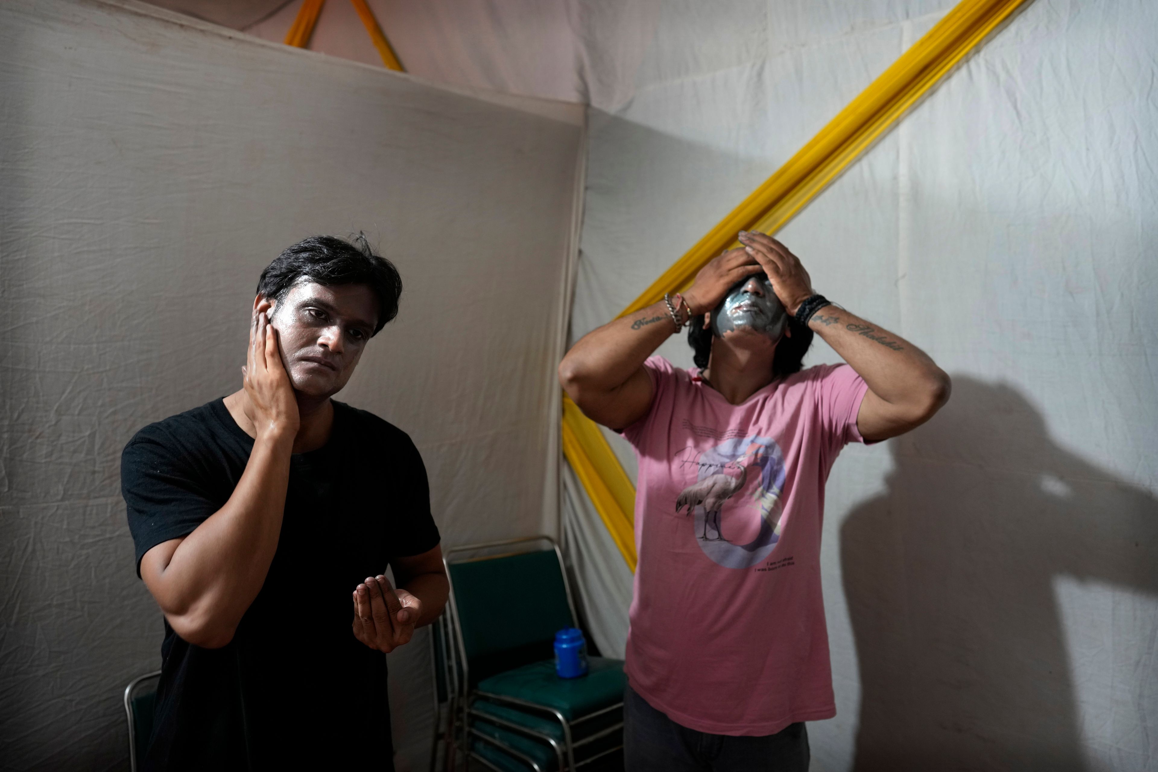 Actors take off their makeup off backstage after performing in Ramleela, a dramatic folk re-enactment of the life of Hindu god Rama according to the ancient Hindu epic Ramayana, in New Delhi, India, Wednesday, Oct. 9, 2024. (AP Photo/Manish Swarup)