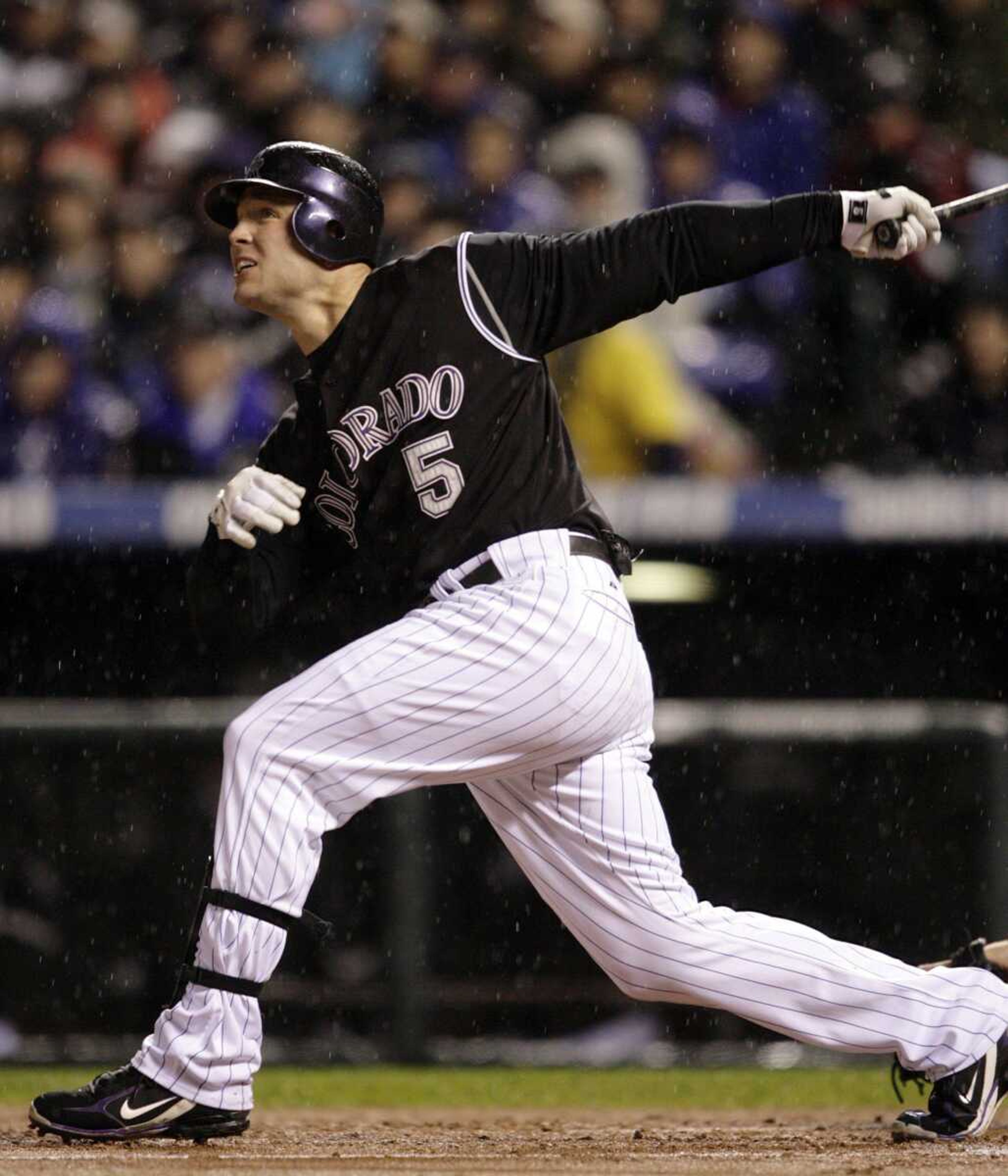 The Colorado Rockies' Matt Holliday watched his first-inning home run Sunday off Arizona Diamondbacks pitcher Livan Hernandez in Game 3 of the National League Championship Series in Denver. (DAVE ZALUBOWSKI ~ Associated Press)