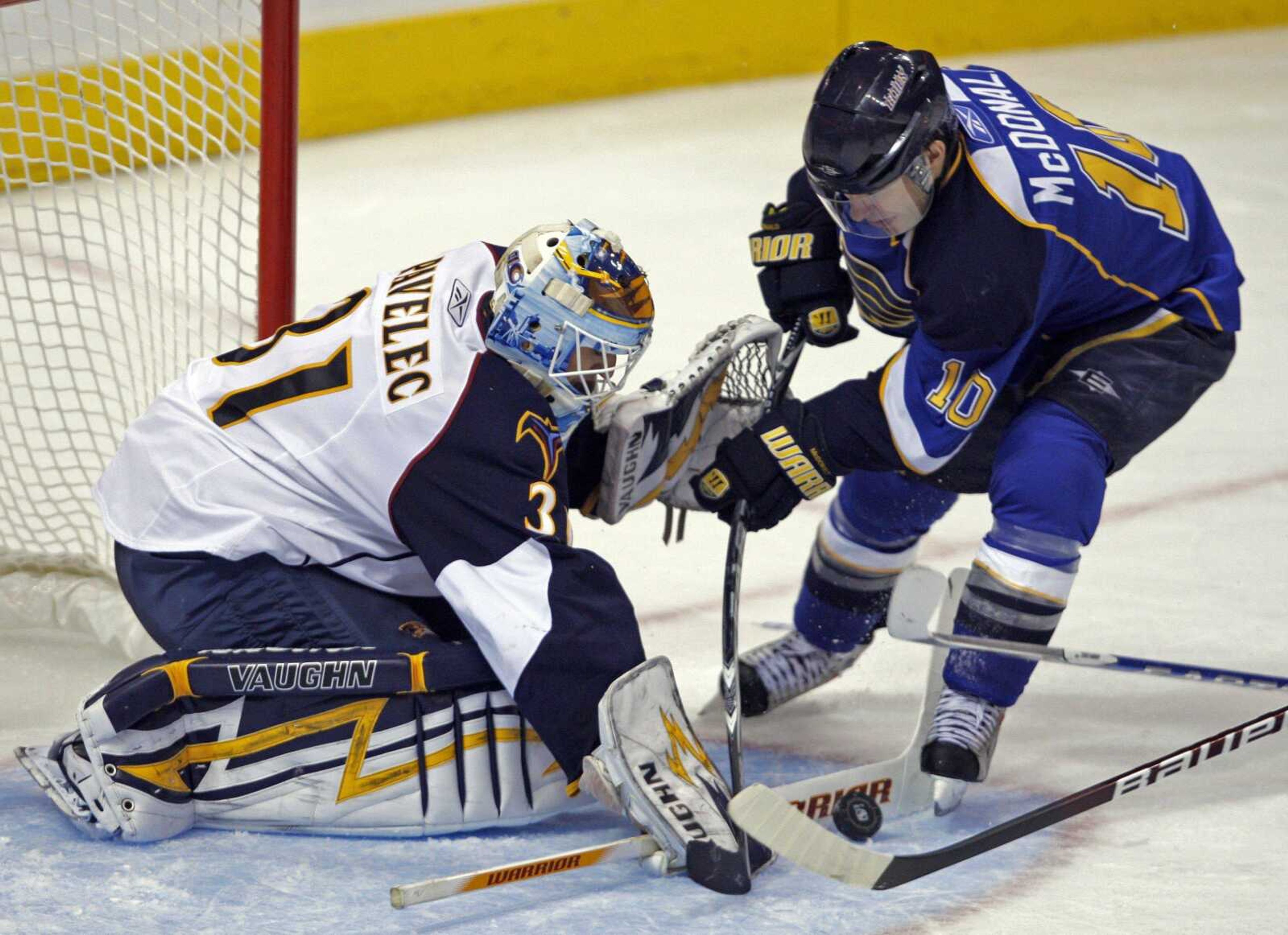 Thrashers goalie Ondrej Pavelec, of the Czech Republic, stops a point-blank shot from the Blues' Andy McDonald in the third period Thursday in St. Louis.<br>Tom Gannam<br> Associated Press