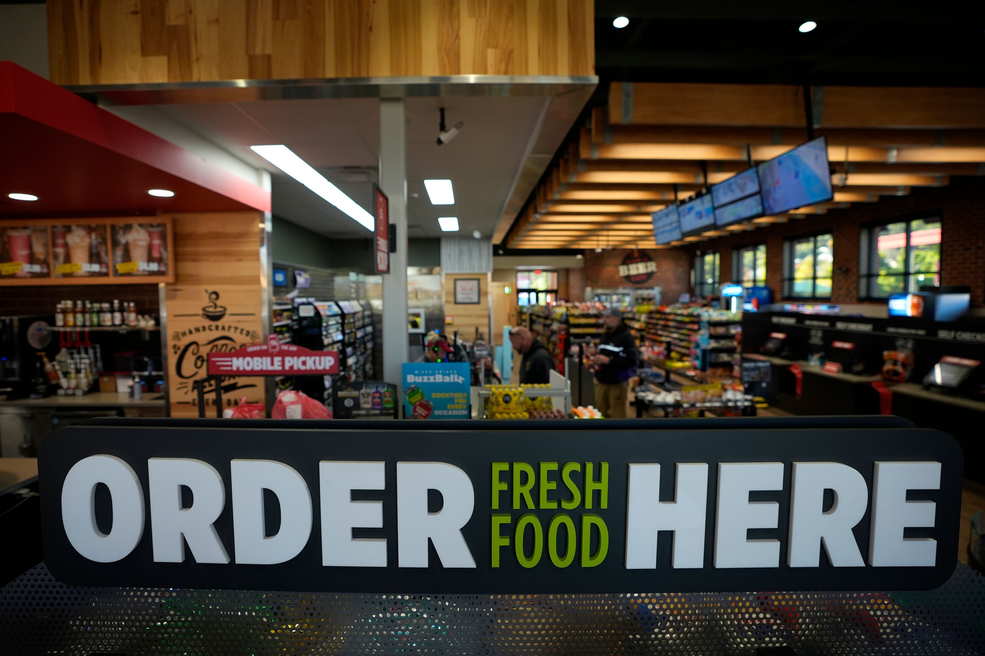 Customers checkout at a Sheetz convenience store, Thursday, Oct. 17, 2024, in Bethlehem, Pa. (AP Photo/Matt Slocum)