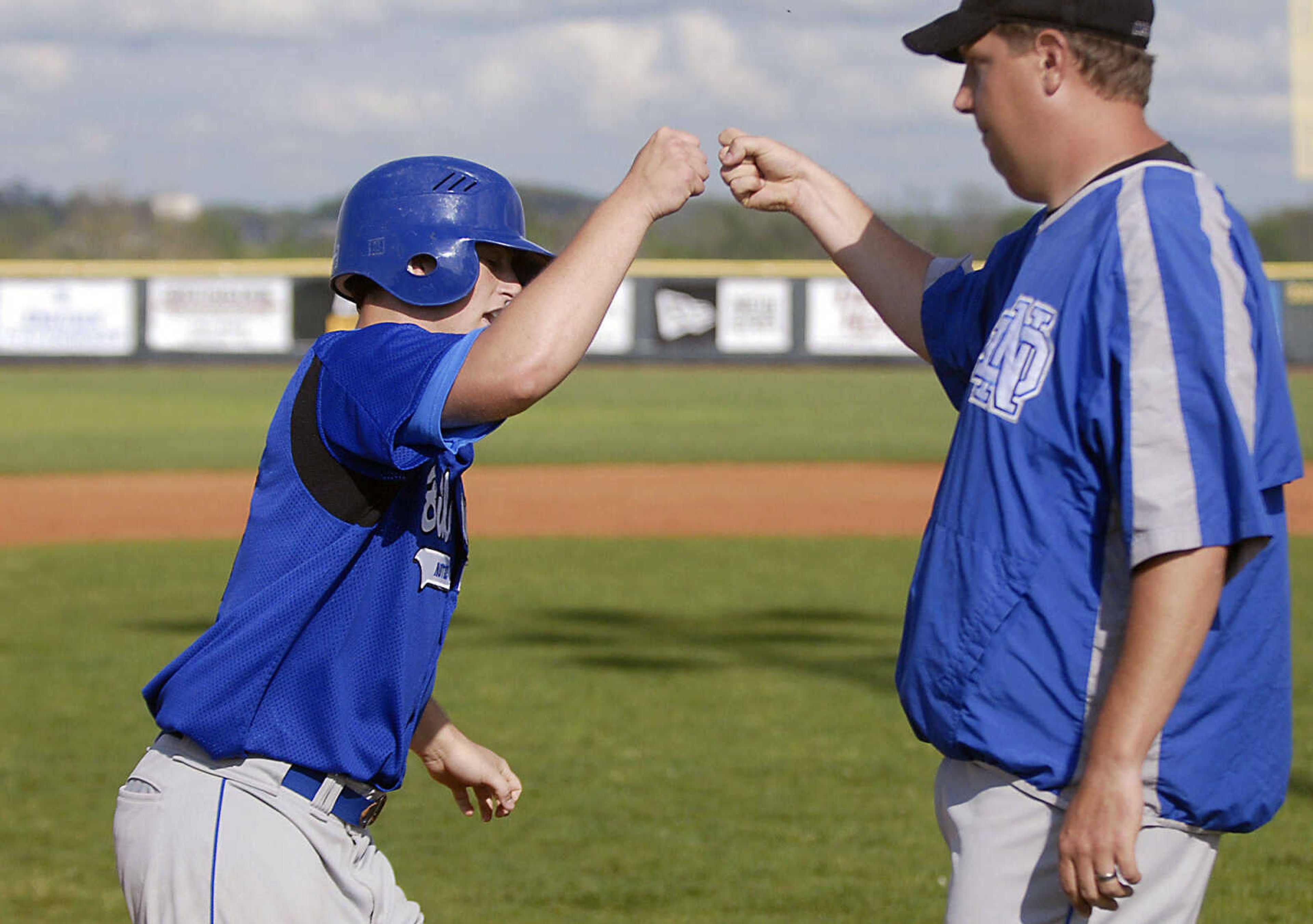 Notre Dame coach Jeff Graviett congratulates Dylan Drury on a homer Tuesday, April 28, 2009, against Sikeston in Cape Girardeau.