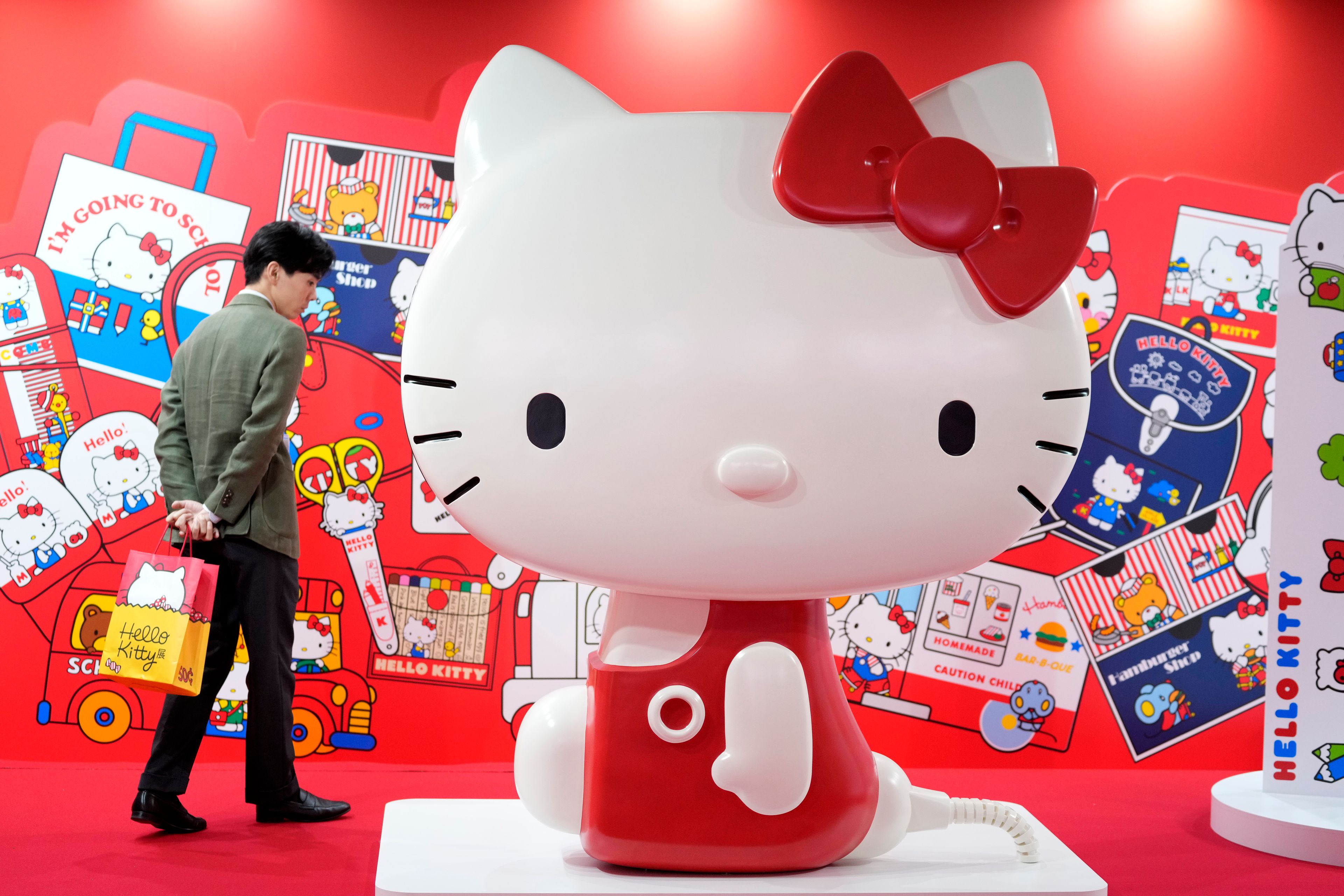 A visitor looks at giant Hello Kitty display at the exhibition "As I change, so does she," marking the 50th anniversary of Hello Kitty at the Tokyo National Museum in Tokyo Wednesday, Oct. 30, 2024. (AP Photo/Shuji Kajiyama)