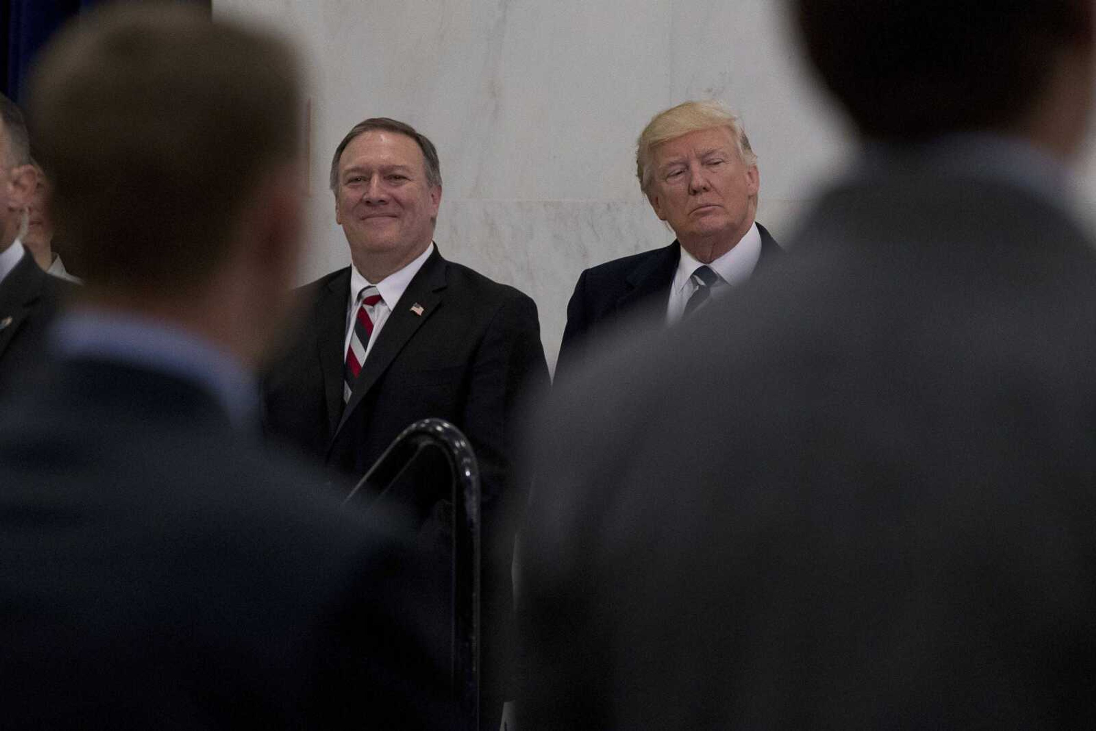 President Donald Trump, accompanied by CIA director-designate Mike Pompeo, left, wait Saturday to speak at the CIA in Langley, Virginia.