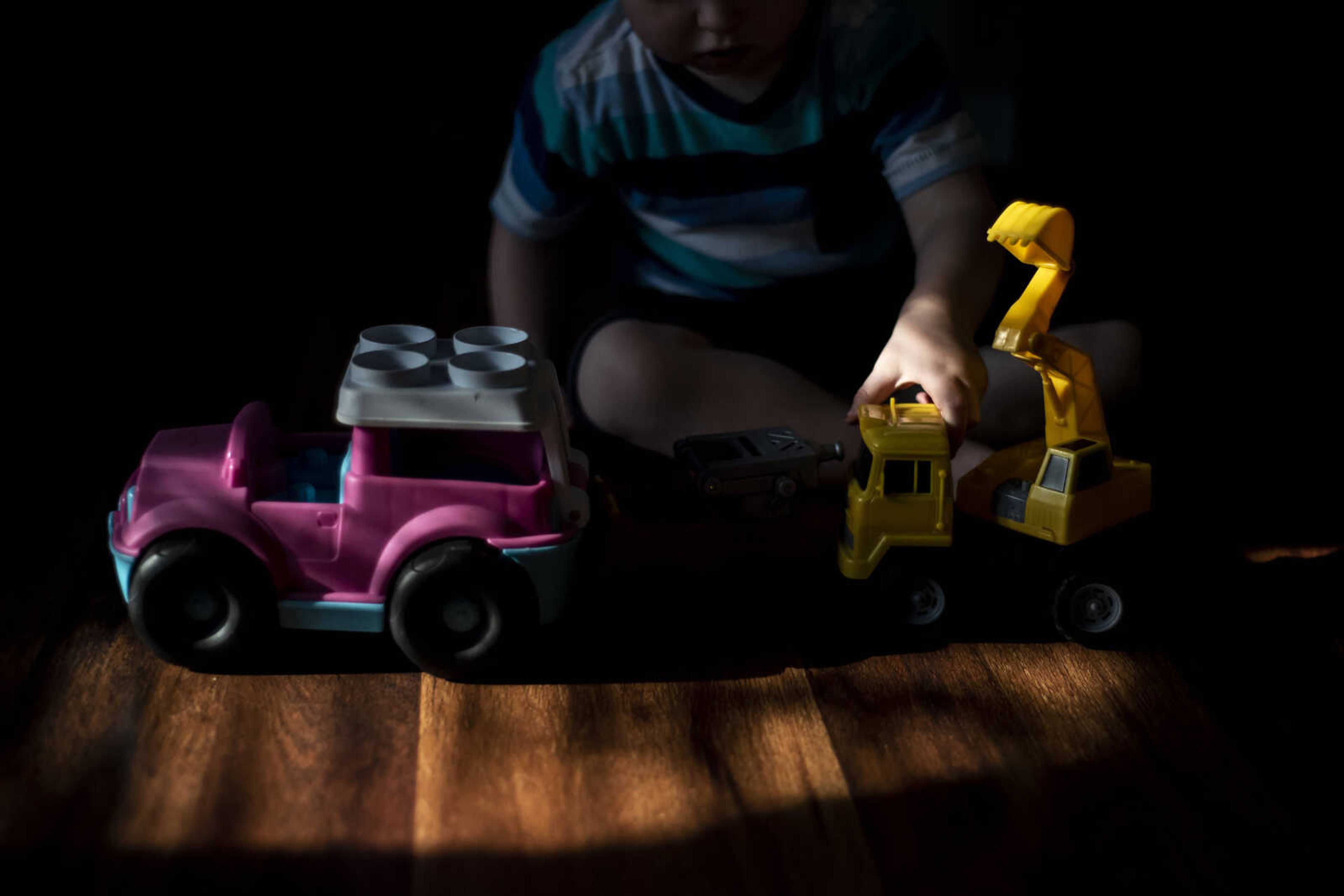 Phoenix Young, 2, lines up his toy trucks in the living room at home Tuesday, May 7, 2019, in Cape Girardeau.