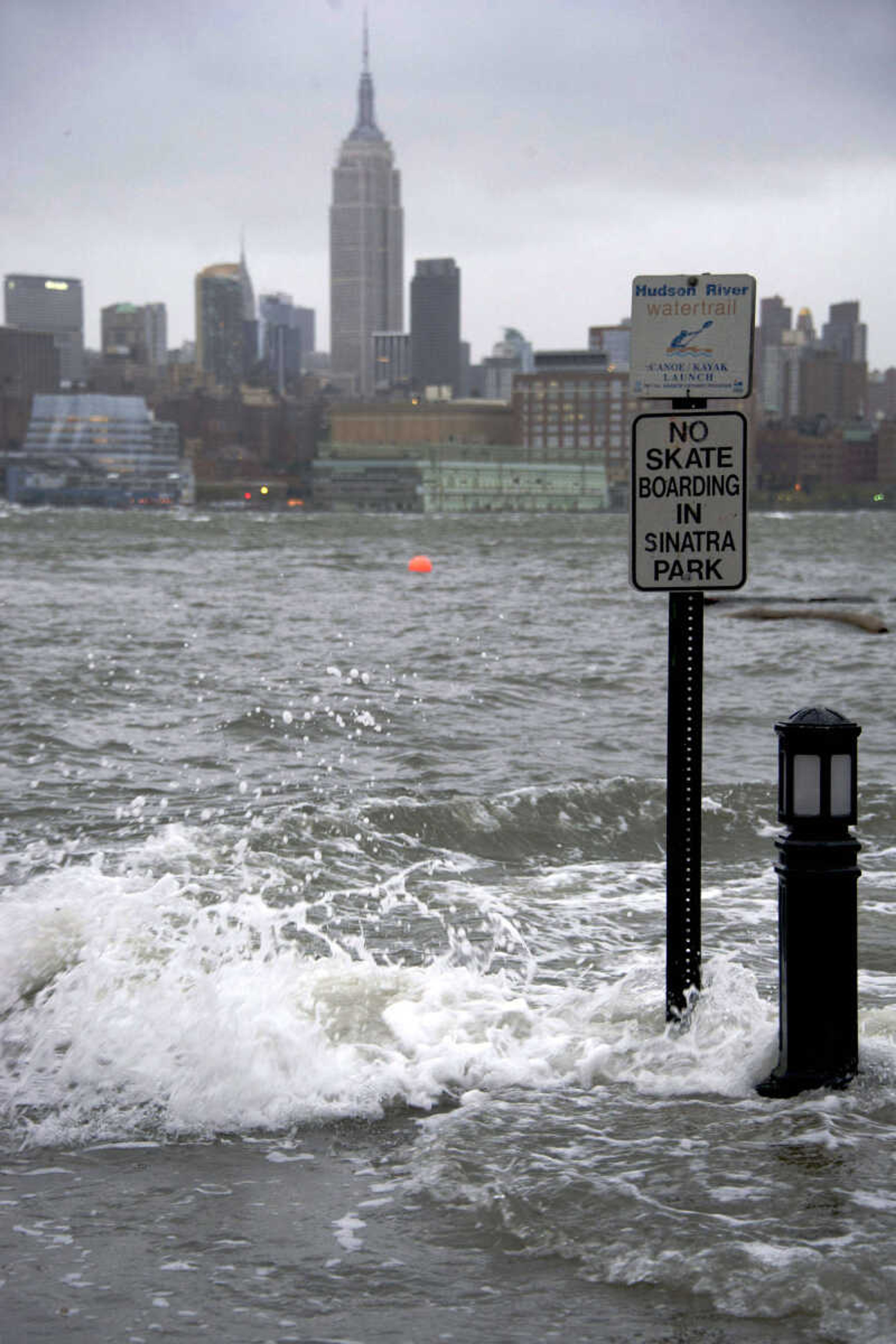 The Hudson River swells and rises over the banks of the Hoboken, N.J. waterfront as Hurricane Sandy approaches on Monday, Oct. 29, 2012. Hurricane Sandy continued on its path Monday, forcing the shutdown of mass transit, schools and financial markets, sending coastal residents fleeing, and threatening a dangerous mix of high winds and soaking rain.Ę(AP Photo/Charles Sykes) (AP Photo/Charles Sykes)