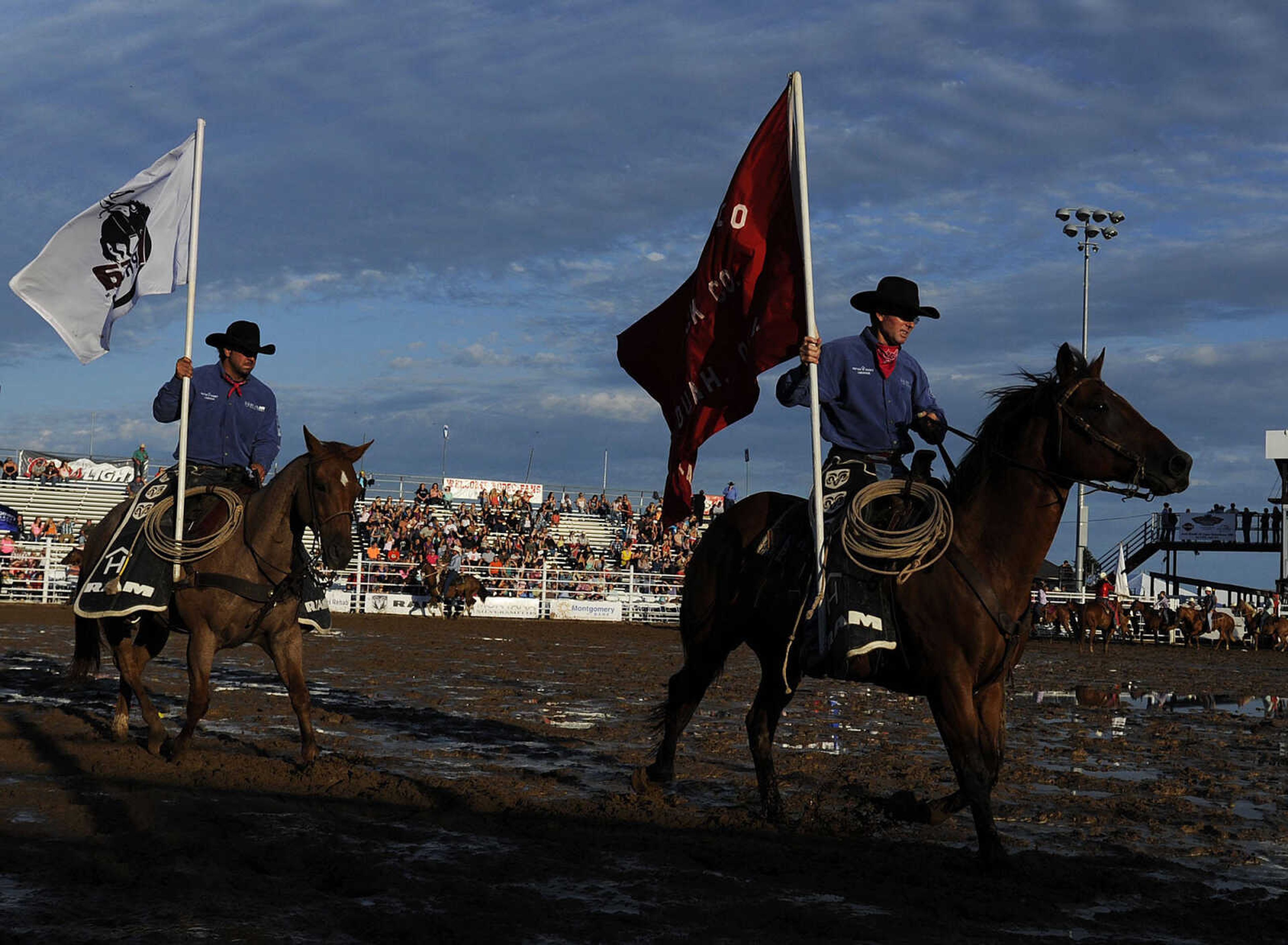 The Grand Entry circles the arena at the start of the Sikeston Jaycee Bootheel Rodeo Wednesday, August 7, in Sikeston, Mo.