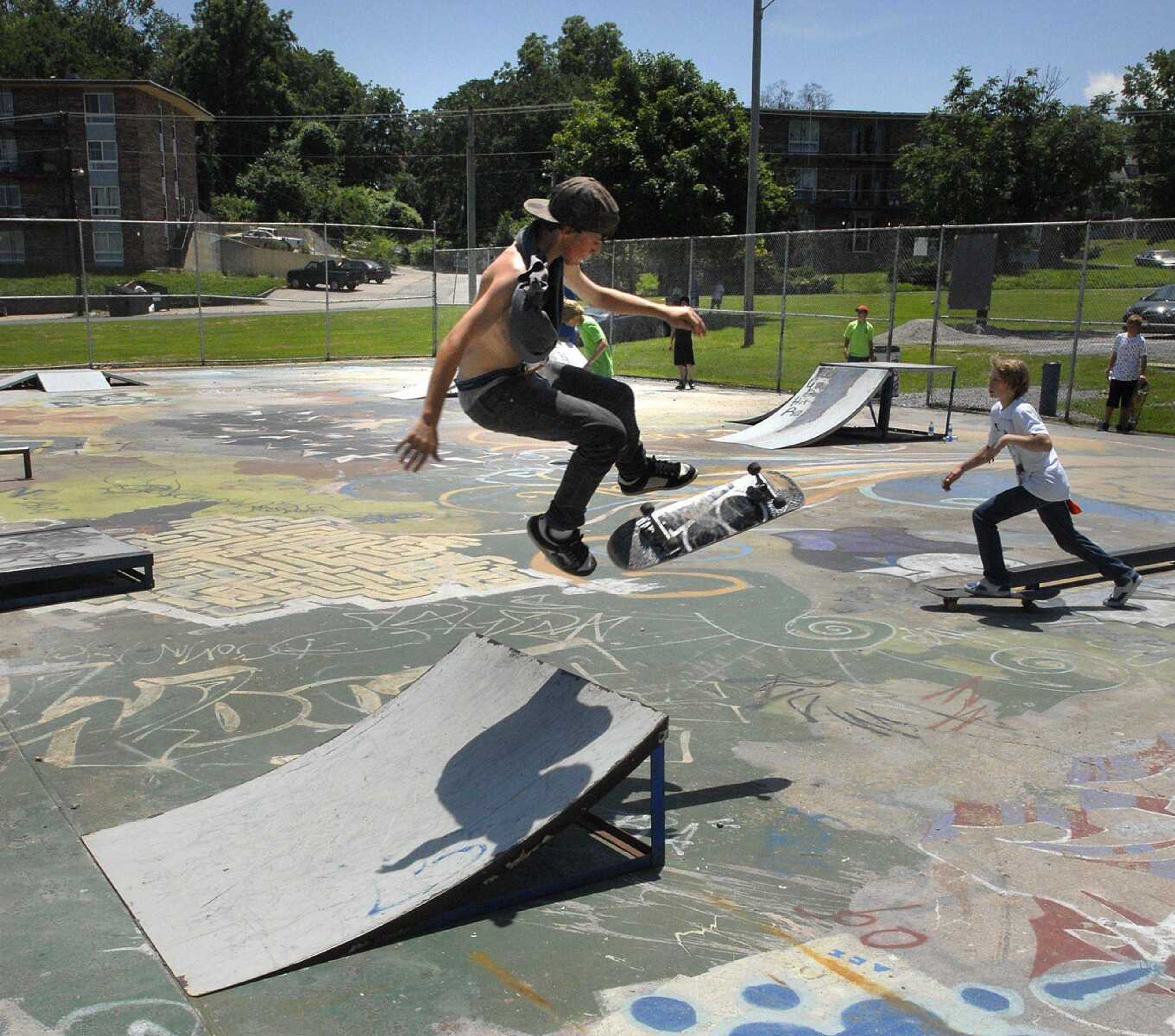 Christopher "Lane" Quillin jumps a ramp as skateboarders test their abilities at Missouri Park after the skateboard parade Sunday. (Fred Lynch)