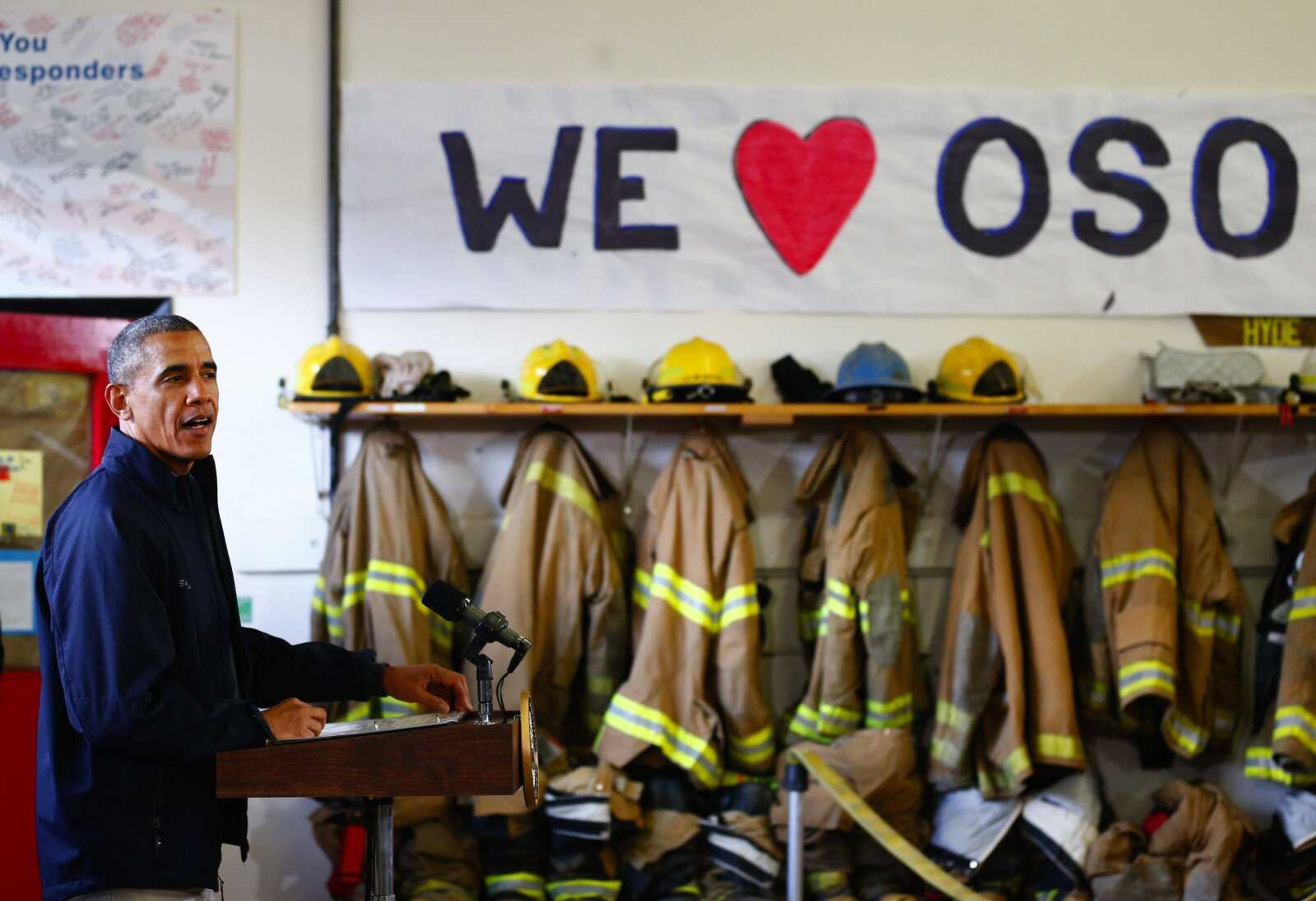 President Barack Obama, left, makes his remarks inside the Oso Fire Department after surveying the damage and response efforts Tuesday in Oso, Wash., one month after a massive mudslide that killed 41 people. (Lindsey Wasson ~ The Seattle Times)