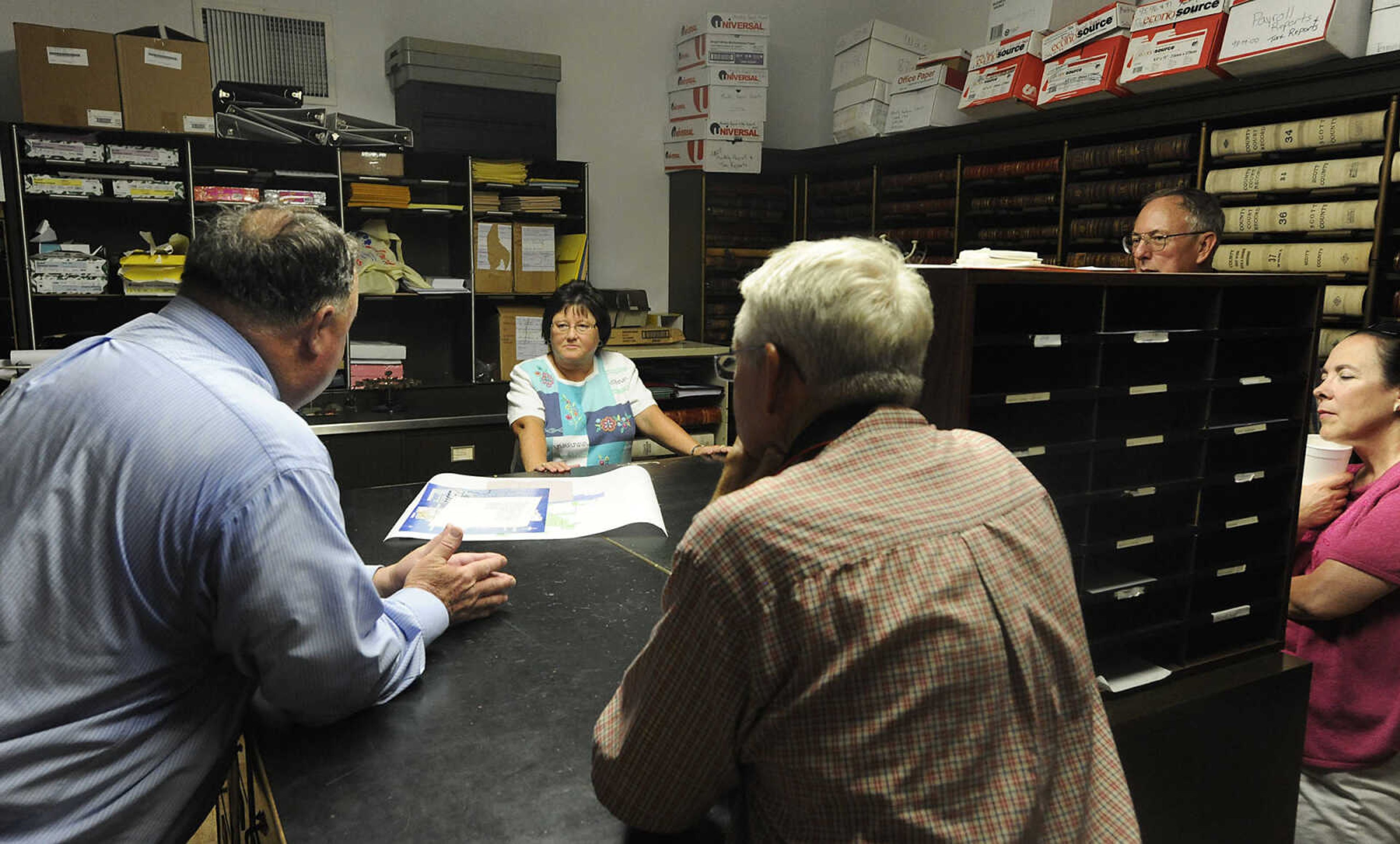 Scott County Clerk Rita Milam gives a tour of the Scott County Courthouse's records vault during the celebration in honor of the centennial of the courthouse in Benton Saturday, June 16. The building, the sixth courthouse for Scott County, was designed by Henry H. Hohenschild in 1912 and dedicated on April 20, 1914.  The courthouse was placed on the National Register of Historic Places in January 2004.