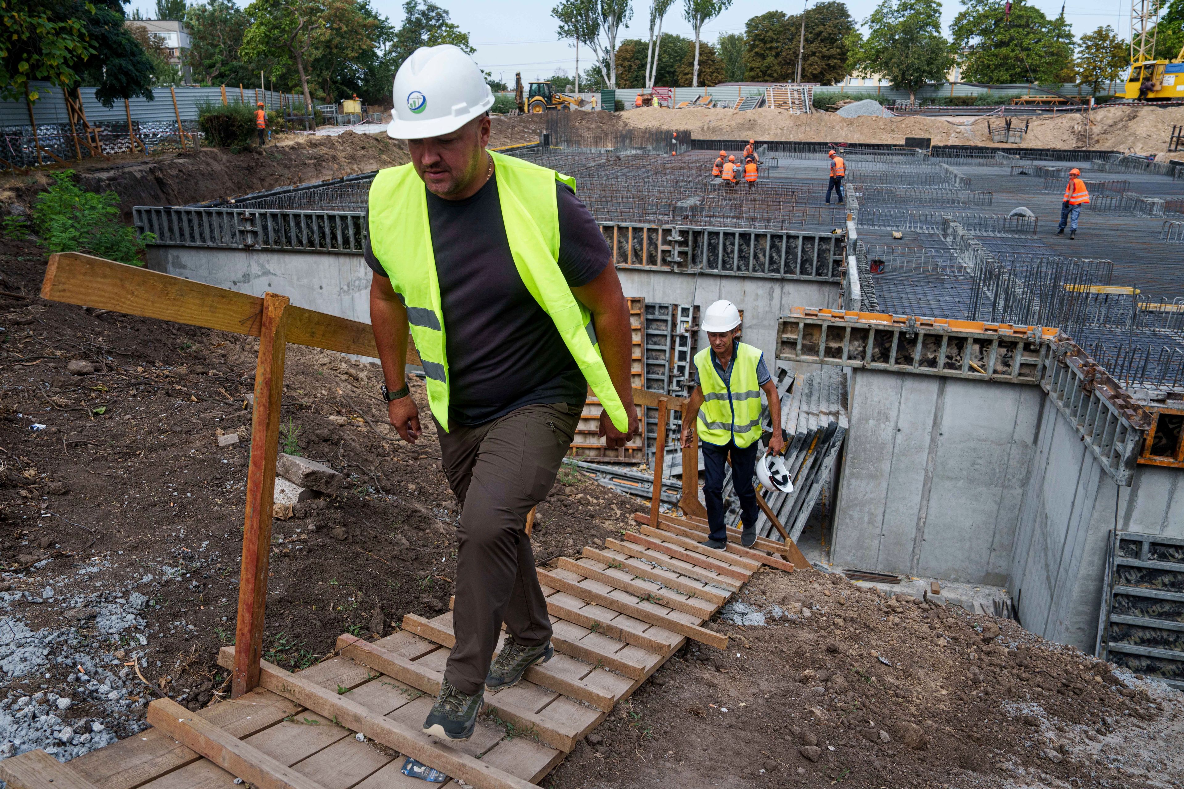 Builders work at the construction site of an underground version of School No. 88 in Zaporizhzhia, Ukraine, August 30, 2024. (AP Photo/Evgeniy Maloletka)