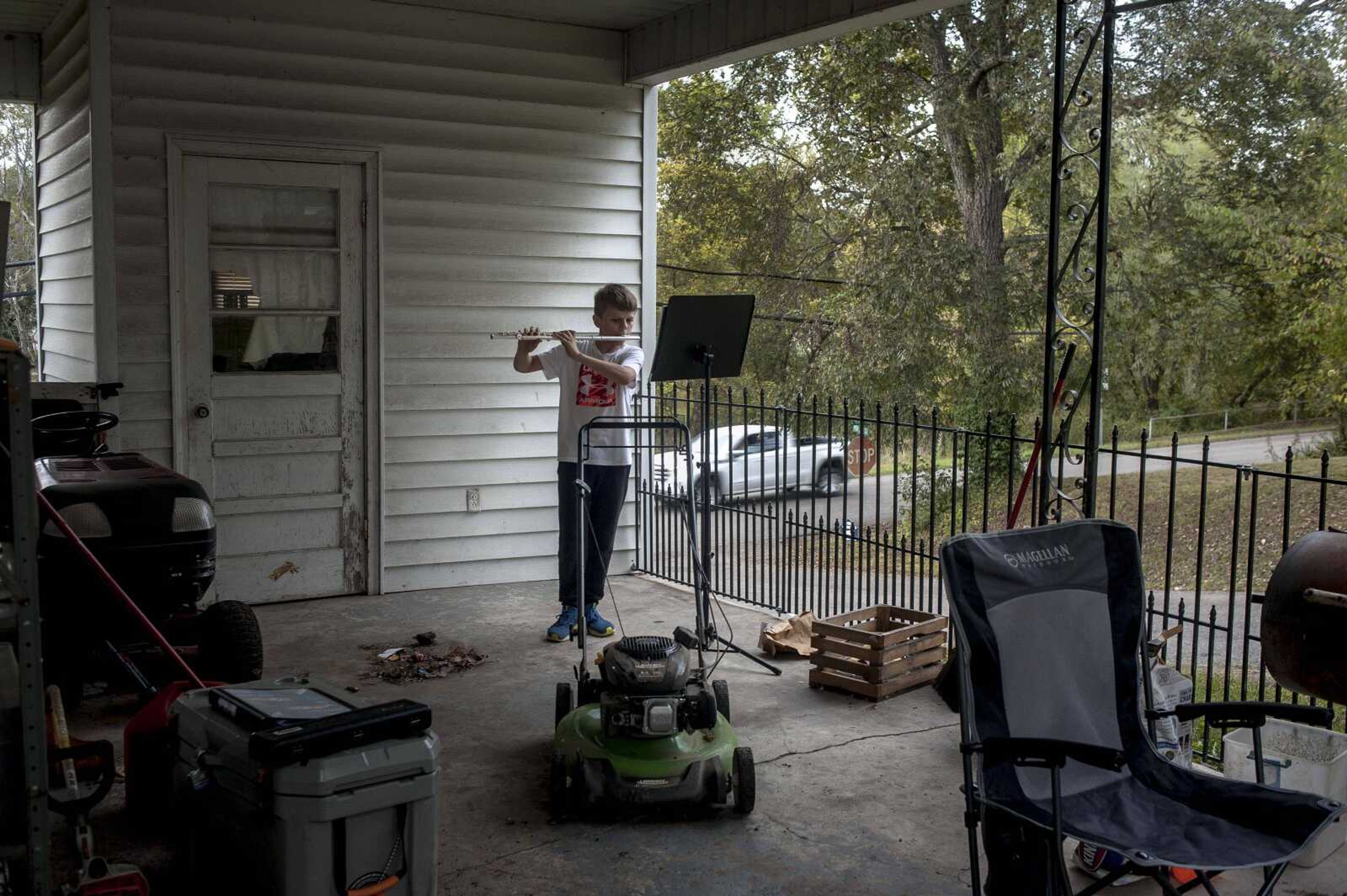 Drake McIntyre, 13, practices playing "Eagle Ridge" on his flute outside his home Thursday, Oct. 10, 2019, in Marble Hill, Missouri. McIntyre said he practices with the Woodland band every day after school and also puts in at least 15 minutes of practice on his own each afternoon. Now in 8th grade, McIntyre picked up the flute last year, in part because his mother, who also plays the instrument, could help tutor him if he got stuck.