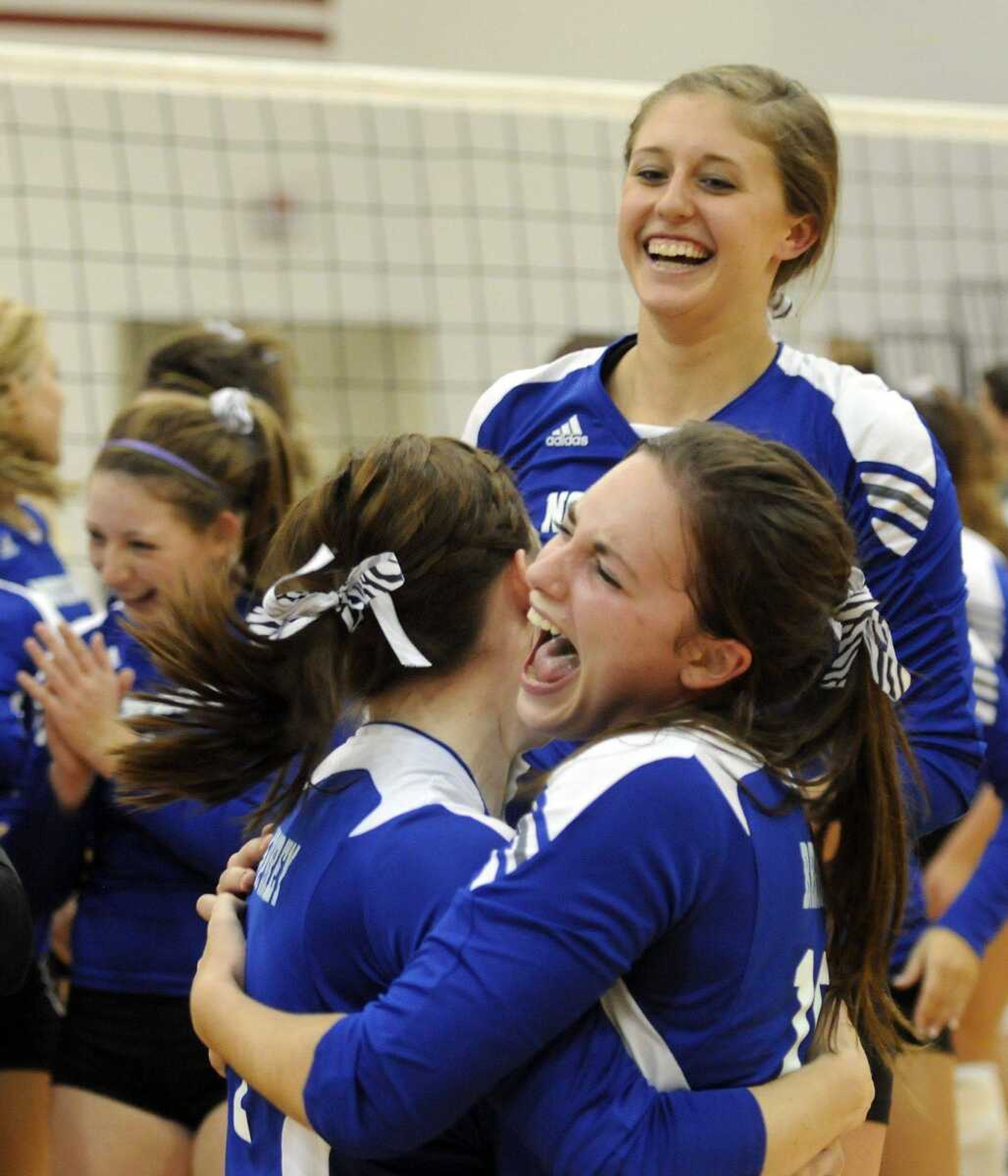 Notre Dame players celebrate their two-game sweep of Perryville in the Class 3 District 1 title match Tuesday in Dexter, Mo. The Bulldogs advanced to the sectional round with a 25-13, 25-20 victory. (KRISTIN EBERTS ~ keberts@semissourian)