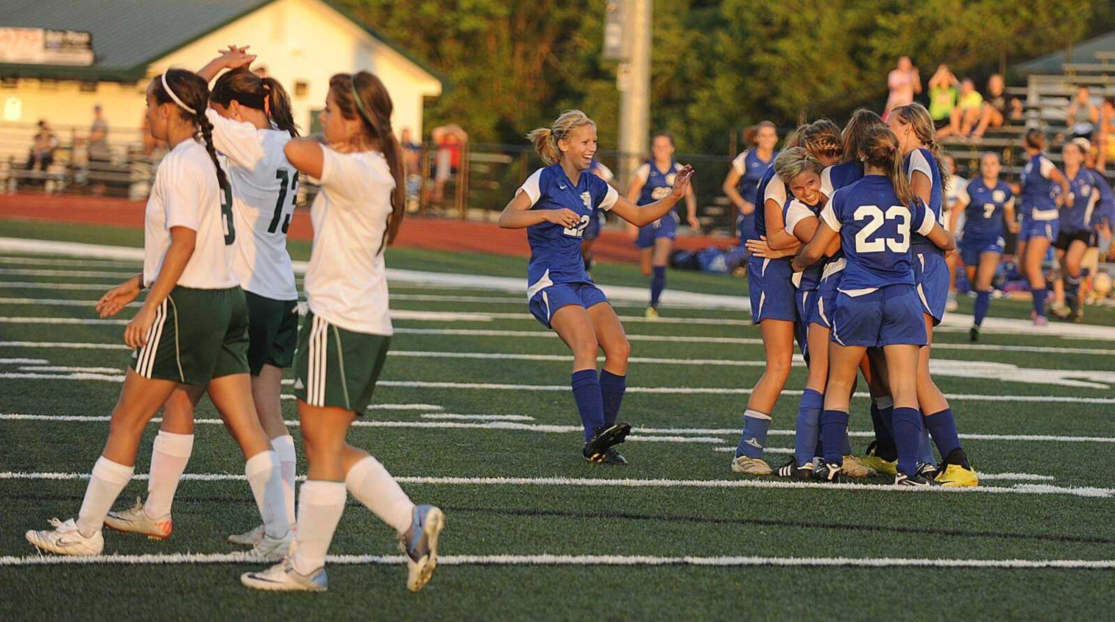 Notre Dame players mob midfielder Brianne Sanders after she scored the winning goal in the Class 2 sectional game.