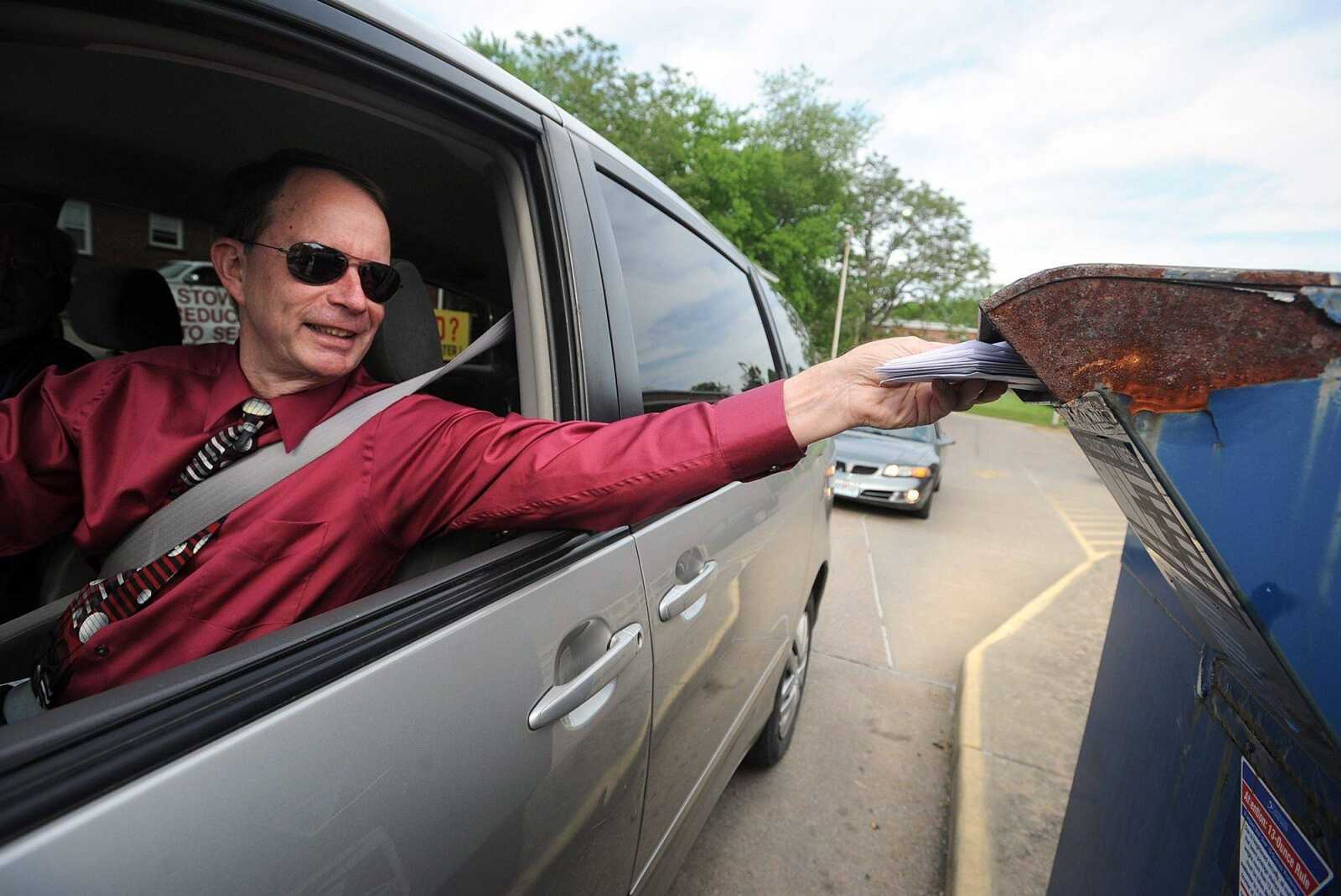 Mike Shivelbine drops a stack of letters into the mailbox outside Cape Girardeau's main post office on Frederick Street, Wednesday, May 8, 2013. (Laura Simon)