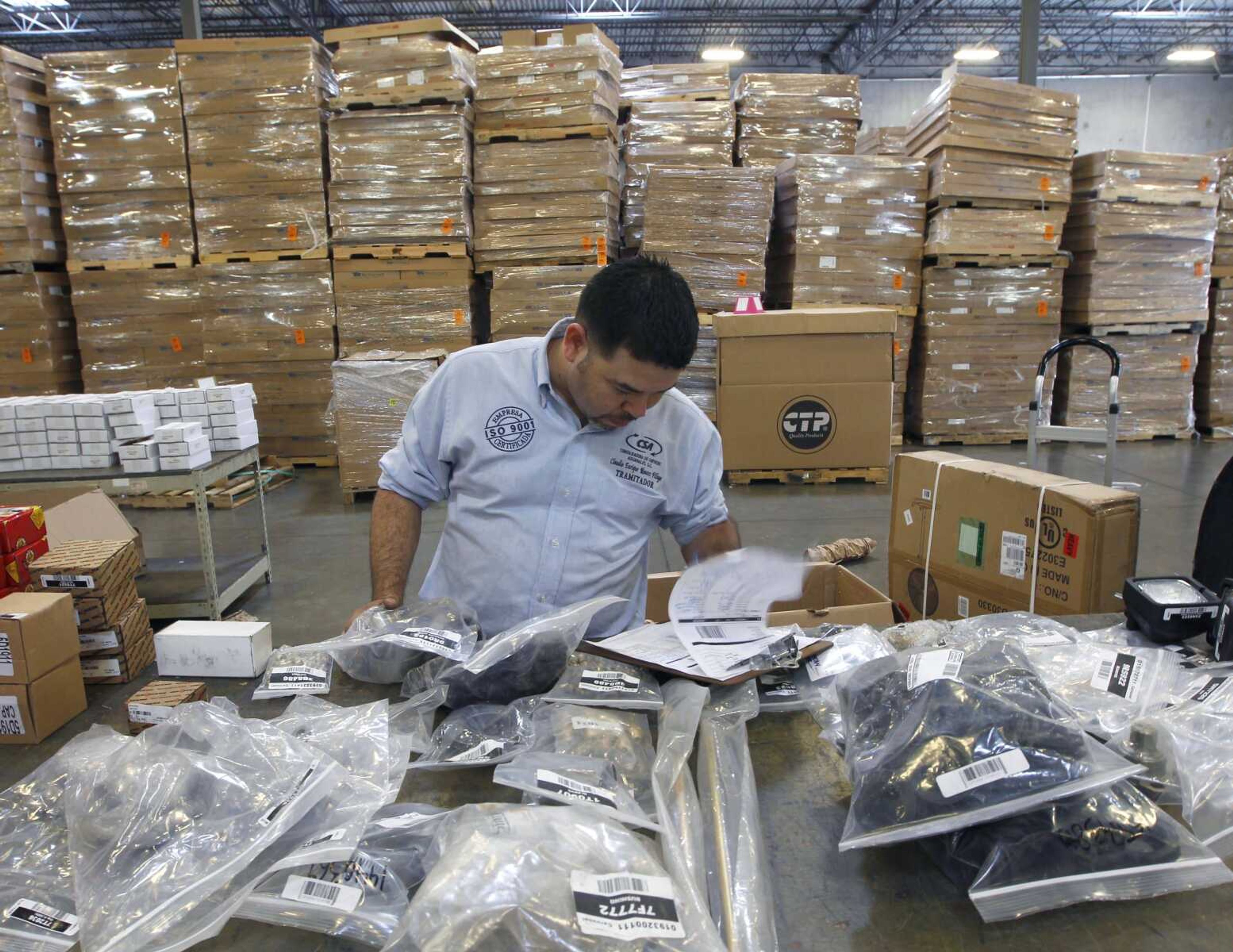 Claudio Montes checks a shipping manifest for U.S. manufactured parts heading to assembly plants in Mexico at Freight Dispatch Service Agency LTD in Pharr, Texas. The freight service ships parts between the U.S. and Mexico that pass through the border freely due to the North American Free Trade Agreement.