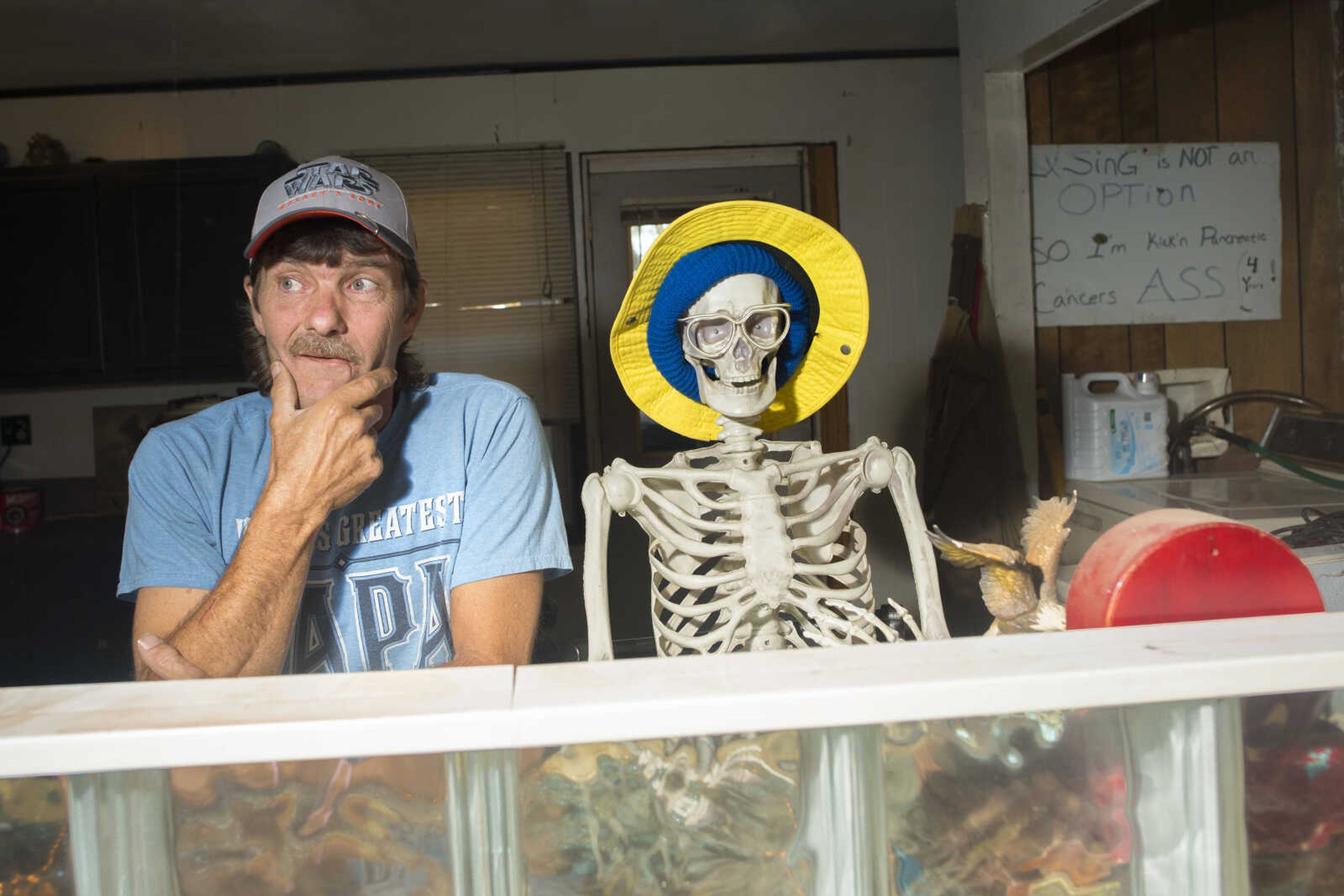 Bob Blackwell poses with his skeleton friend "Bones" in his kitchen Sunday, Nov. 10, 2019, at his home in McClure, Illinois.