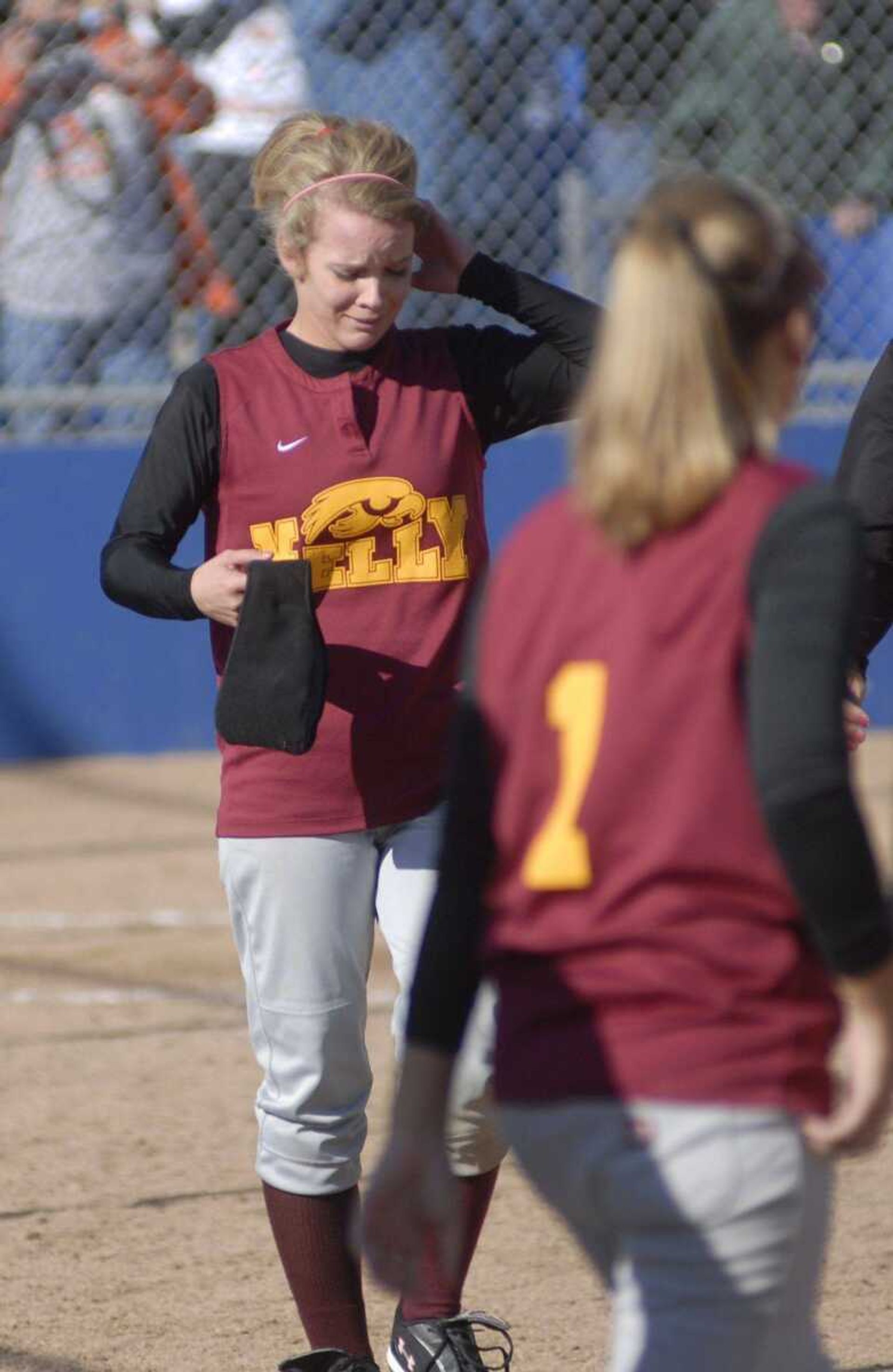 ABOVE: Kelly's Lana Whitworth reacts after the final out. 
BELOW: Kelly's Danielle Dock talks with catcher Brittany Brantley after allowing a run during the fourth inning.