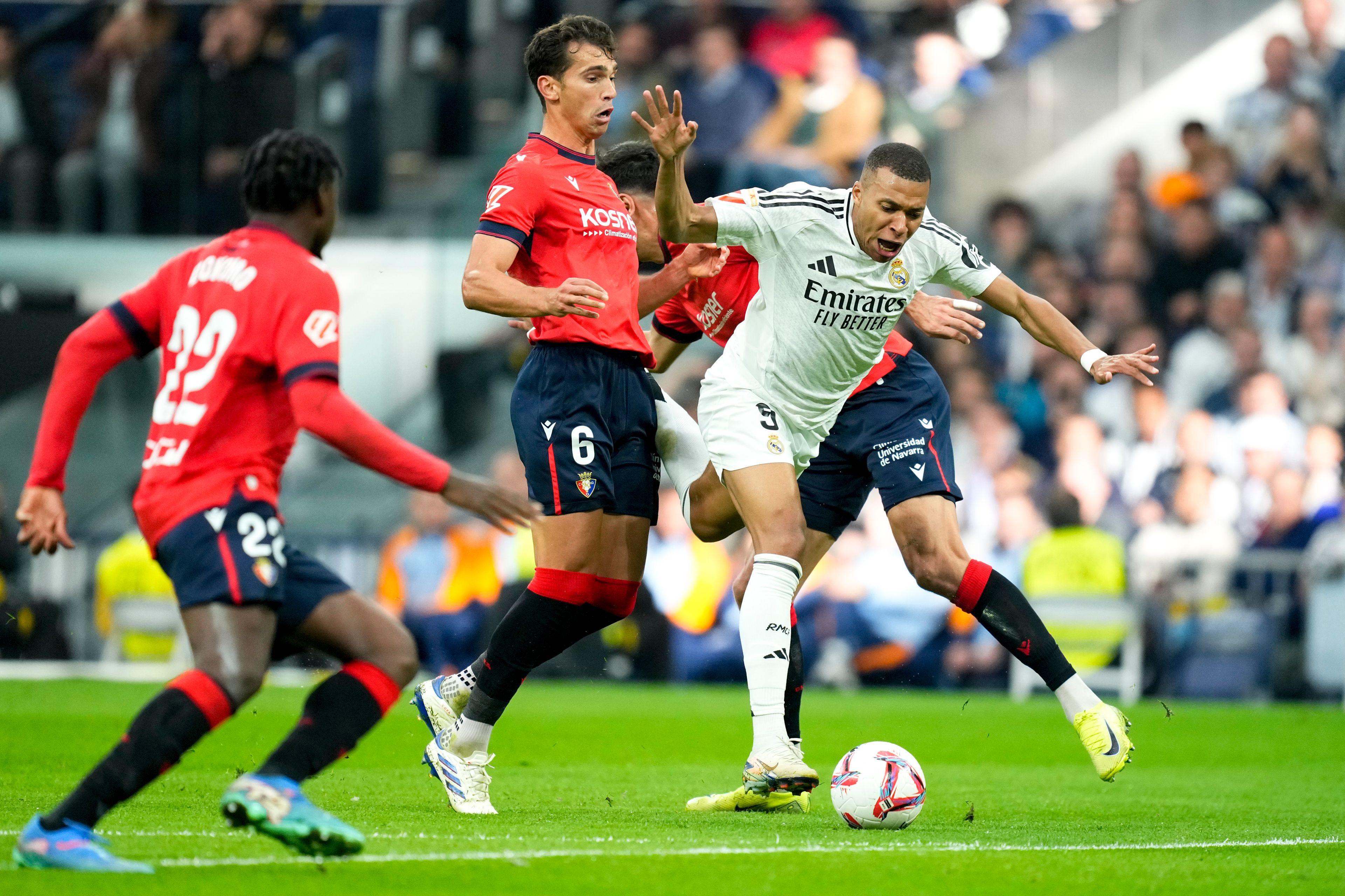 Real Madrid's Kylian Mbappe is challenged by Osasuna's Lucas Torro during the Spanish La Liga soccer match between Real Madrid and Osasuna at the Santiago Bernabeu stadium in Madrid, Spain, Saturday, Nov. 9, 2024. (AP Photo/Jose Breton)