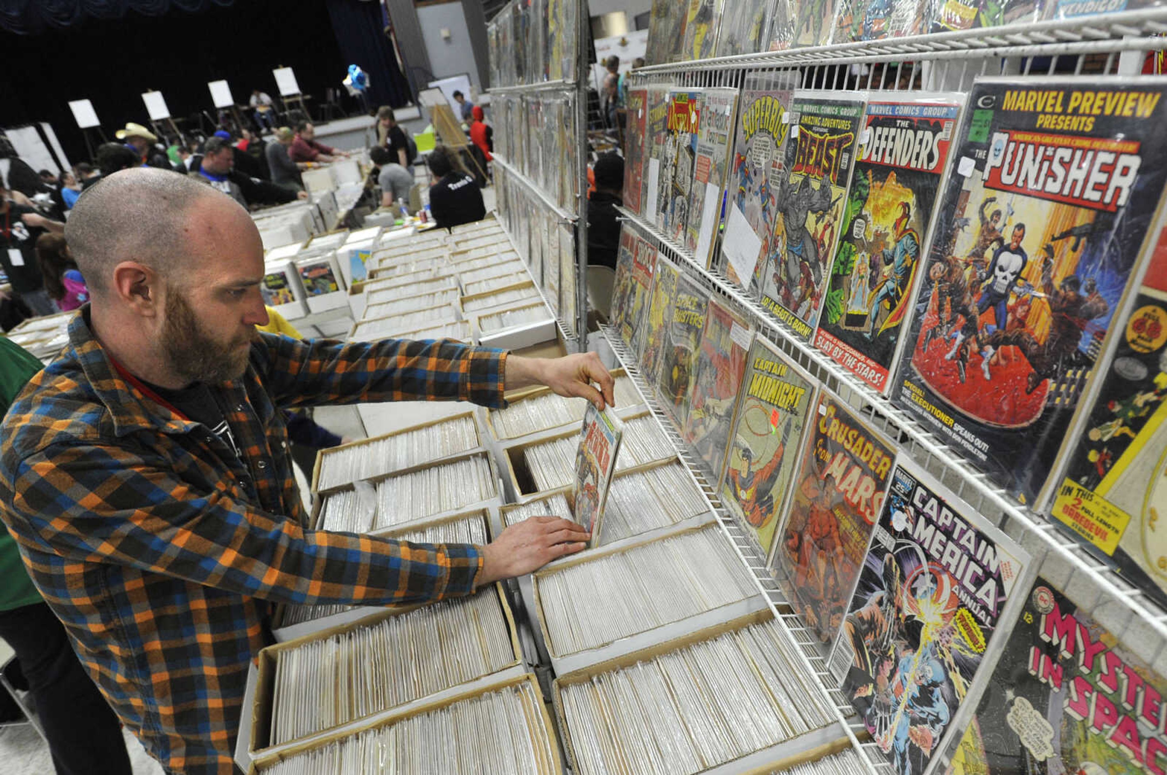 FRED LYNCH ~ flynch@semissourian.com
Adam Martin of Paducah, Ky. checks out the large selection of comic books for sale at Cape Comic Con on Saturday, March 22, 2014 at the Arena Building.