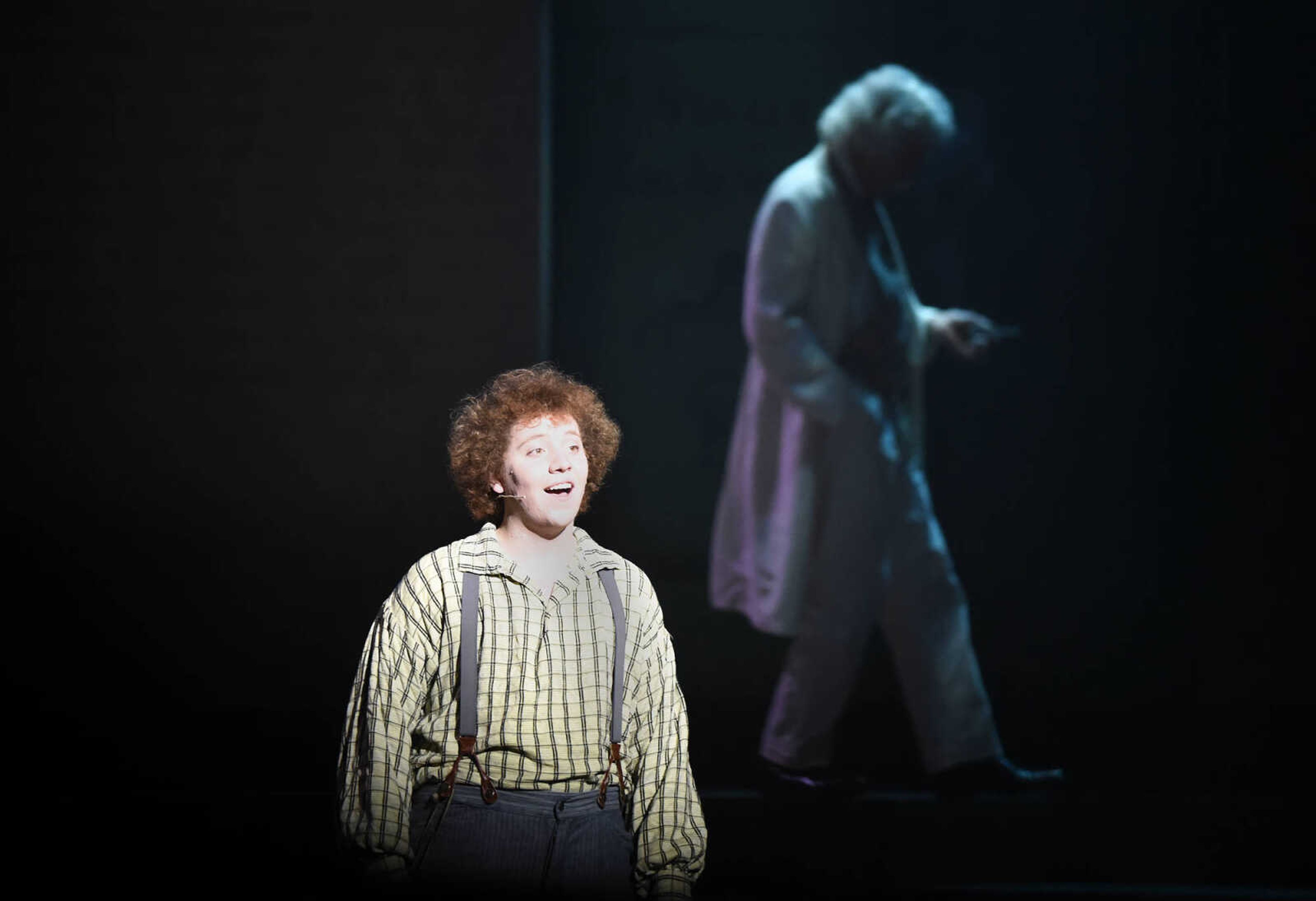 Mark Twain, portrayed by Lester Goodin, mulls about the in the background as Huckleberry Finn, played by Nicholas Kuchem, sings during The Conservatory of Theatre and Dance's production of "Big River: The Adventures of Huckleberry Finn" on Wednesday, Feb. 22, 2017, at Southeast Missouri State University's River Campus. The show runs through Sunday.