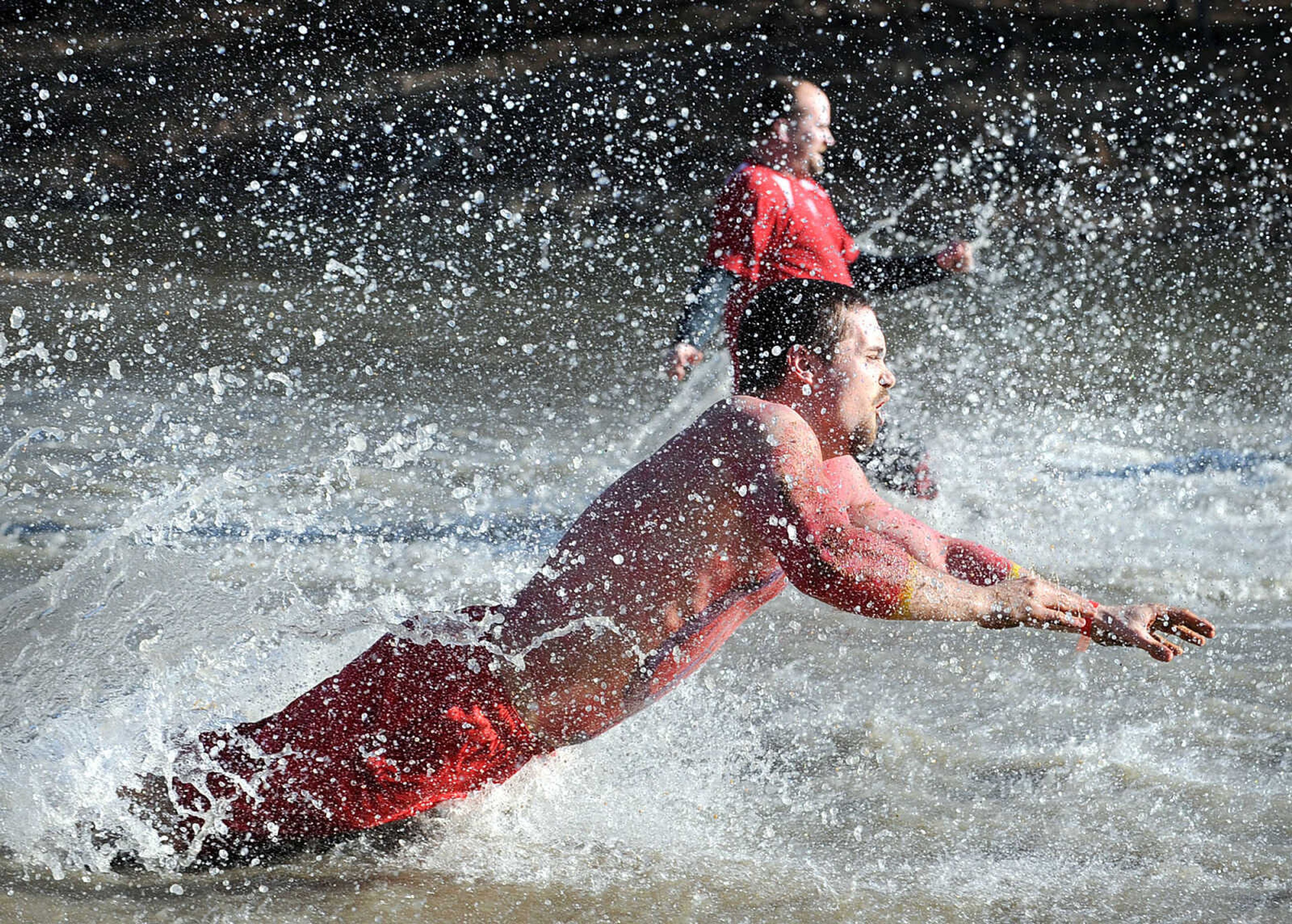 LAURA SIMON ~ lsimon@semissourian.com
People plunge into the cold waters of Lake Boutin Saturday afternoon, Feb. 2, 2013 during the Polar Plunge at Trail of Tears State Park. The lake's water temperature Saturday was 28 degrees. Thirty-six teams totaling 291 people took the annual plunge that benefits Special Olympics. Each team has to raise a minimum of 75 dollars to participate.