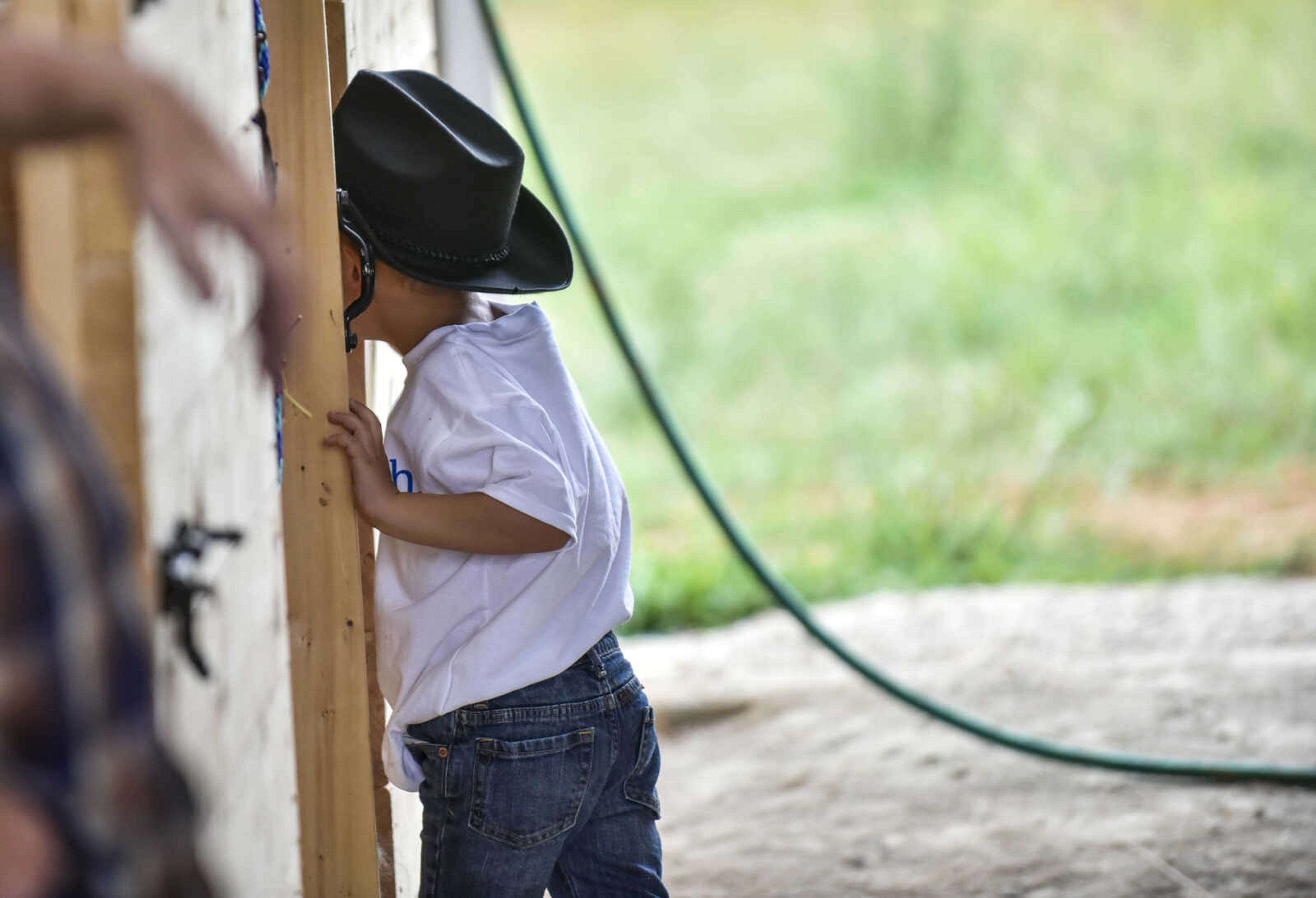 Nate Prichard, 5, sneaks back into the stall of his new horse Monday, July 30, 2018 in&nbsp;Burfordville.