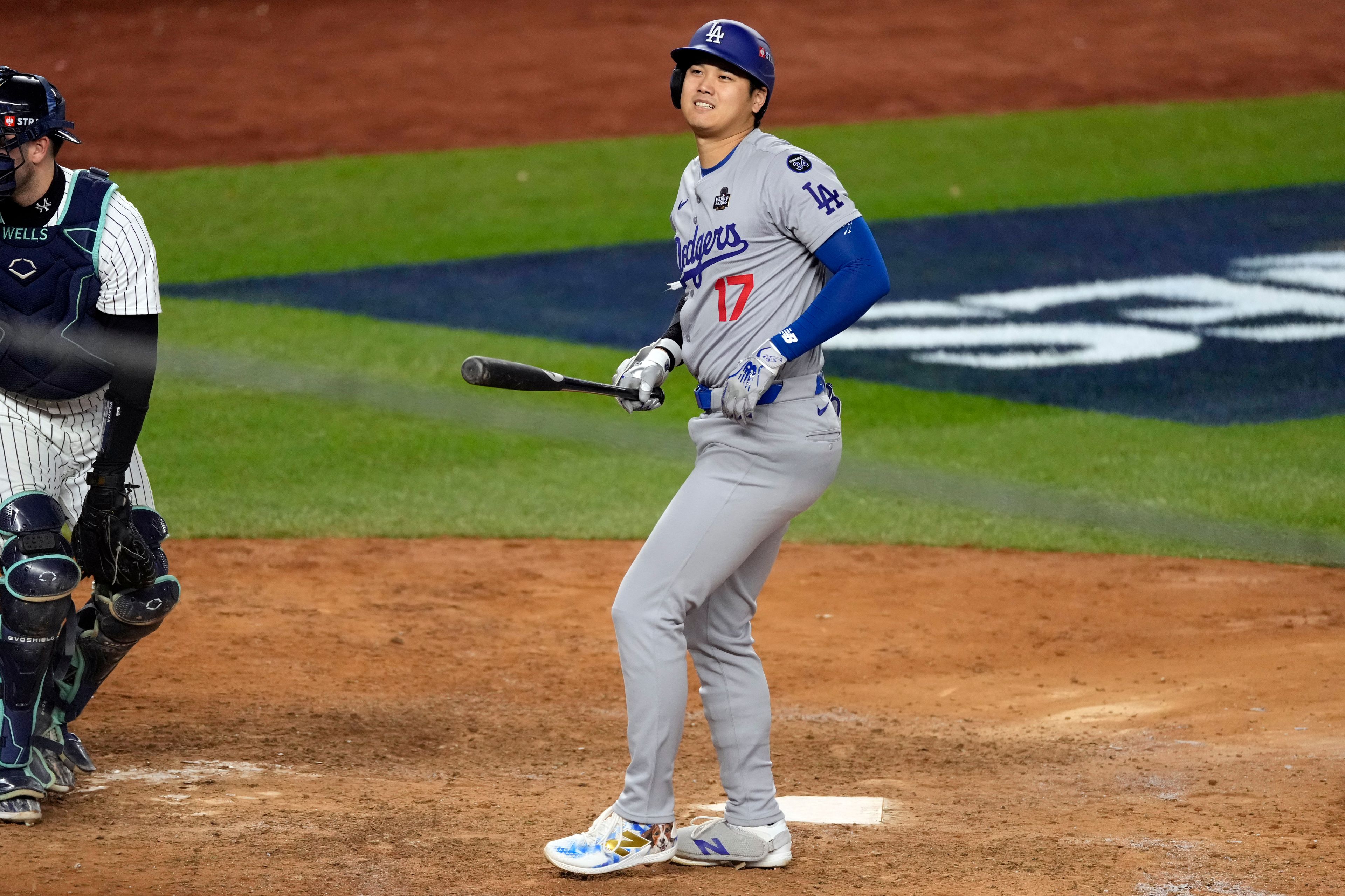 Los Angeles Dodgers' Shohei Ohtani reacts after being hit in the foot by a pitch during the ninth inning in Game 3 of the baseball World Series against the New York Yankees, Monday, Oct. 28, 2024, in New York. (AP Photo/Seth Wenig)