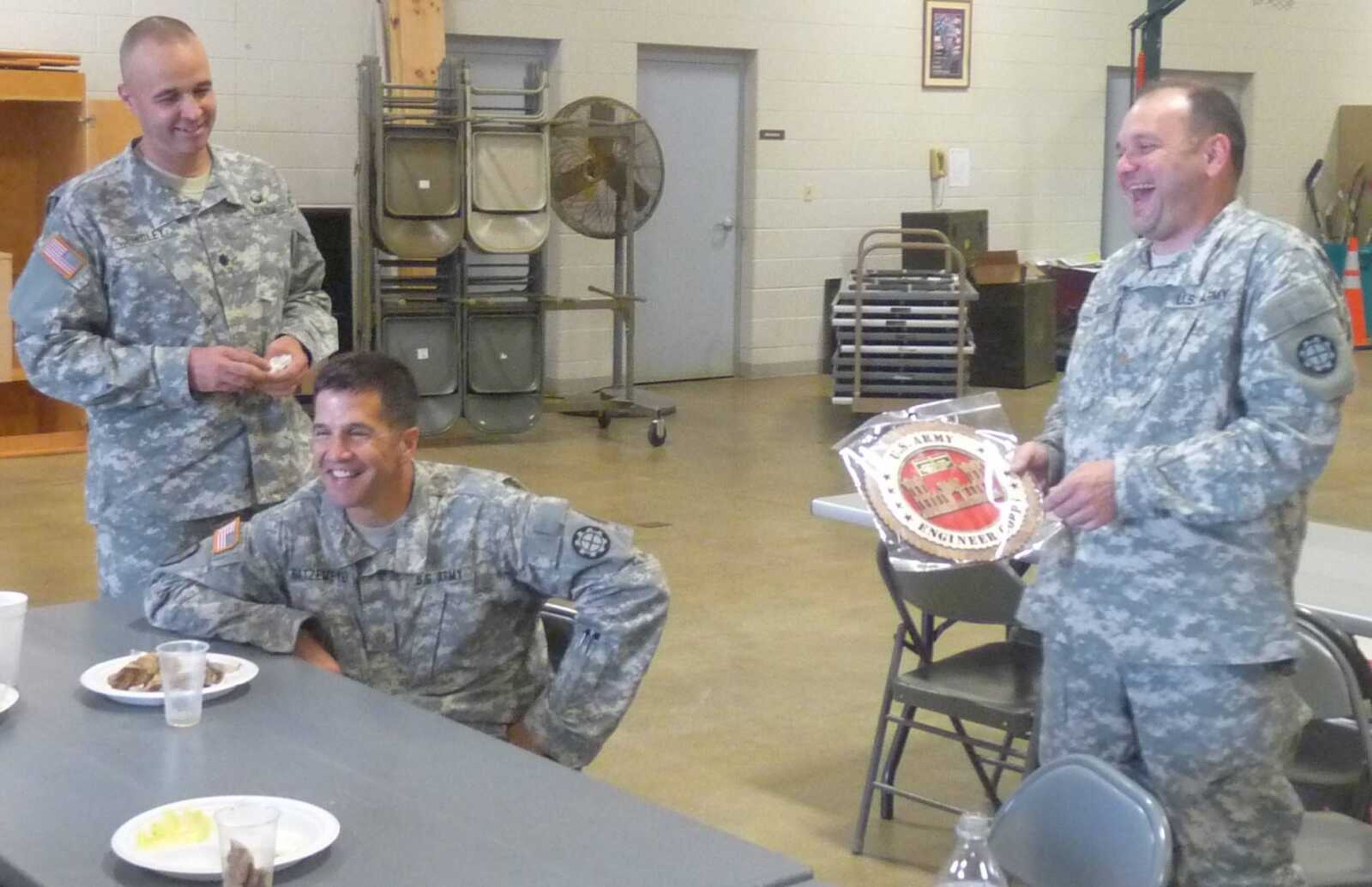 These three Missouri National Guard officers, from left, Lt. Col. John Findley, Maj. Craig Gatzemeyer and Maj. Mike Woods, share a laugh at an informal going-away ceremony for Findley and Woods at the 35th Engineer Brigade, of Fort Leonard Wood. Findley and Woods are moving on to new positions within the Guard, while Gatzemeyer is coming to the brigade as its new administrative officer.
(Photo by Matthew J. Wilson)