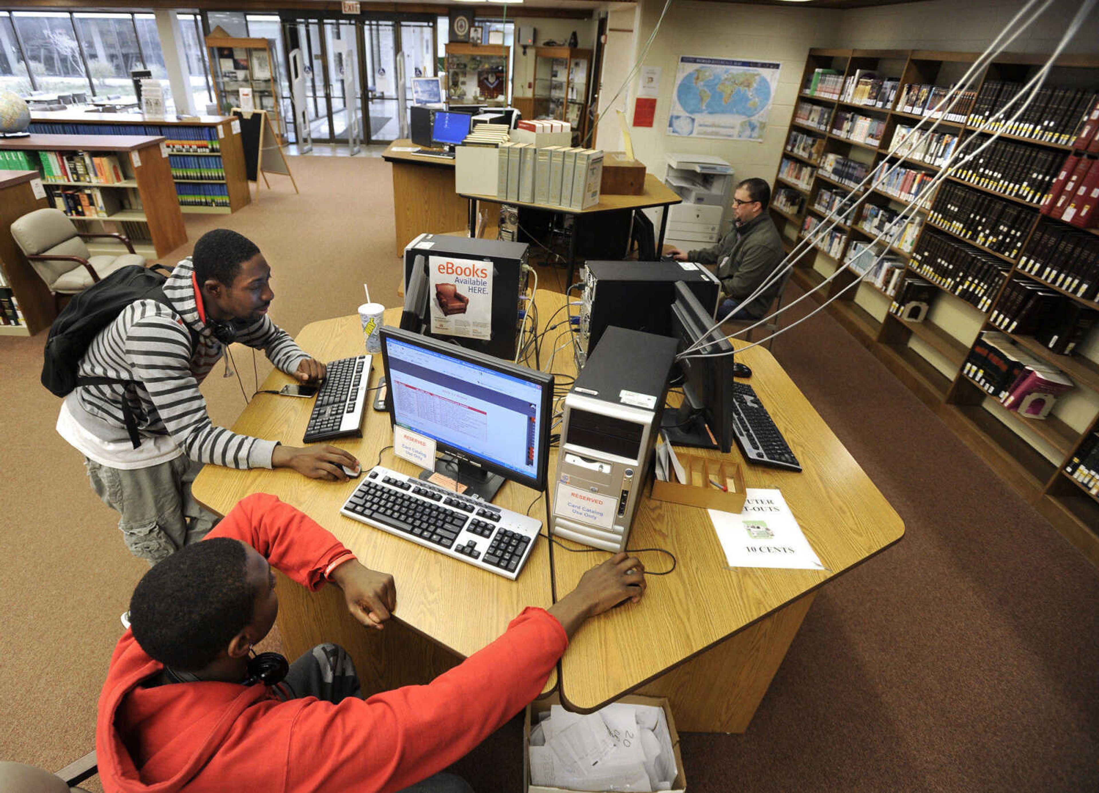 FRED LYNCH ~ flynch@semissourian.com
Corrion Johnson, standing, and Errol Isom use computers Thursday, March 24, 2011 in the C.H. Cozean Library at Mineral Area College in Park Hills, Mo. The computer cables drop from the ceiling next to a sprinkler head.