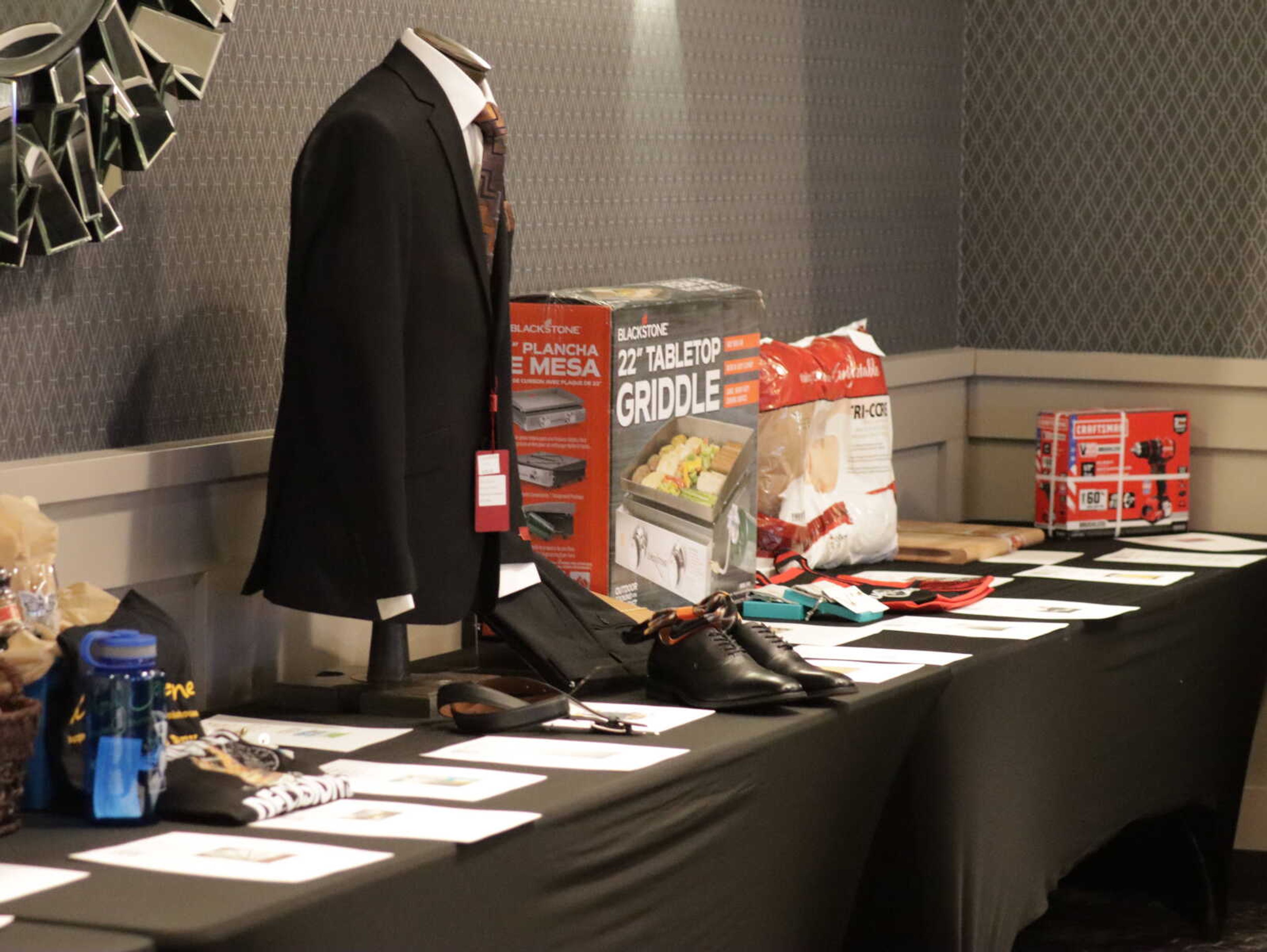 The auction table filled with an array of items for people to bid on.