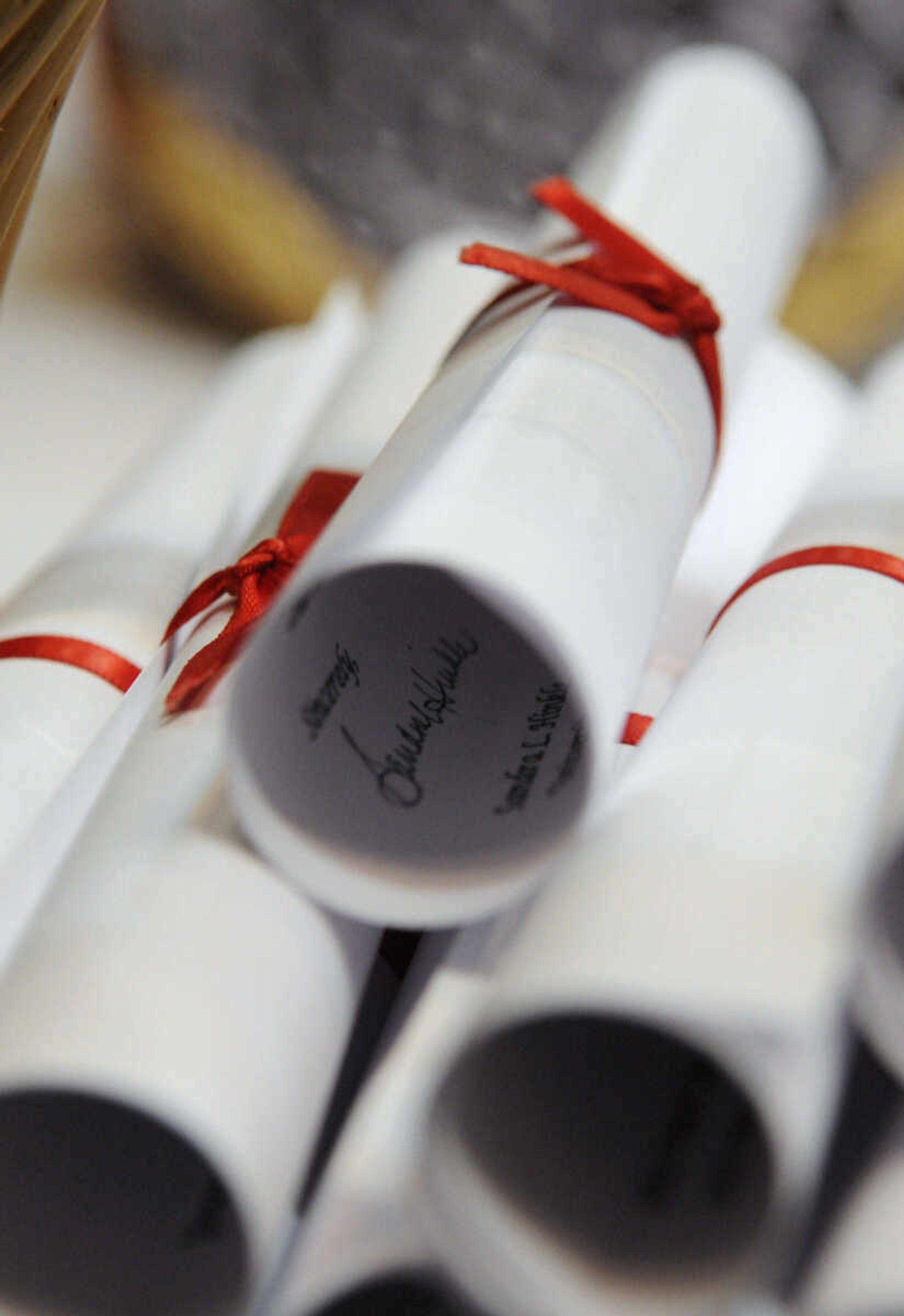 KRISTIN EBERTS ~ keberts@semissourian.com

Diplomas await students at the foot of the stage during Southeast Missouri State University's 2010 Commencement at the Show Me Center on Saturday, May 15.