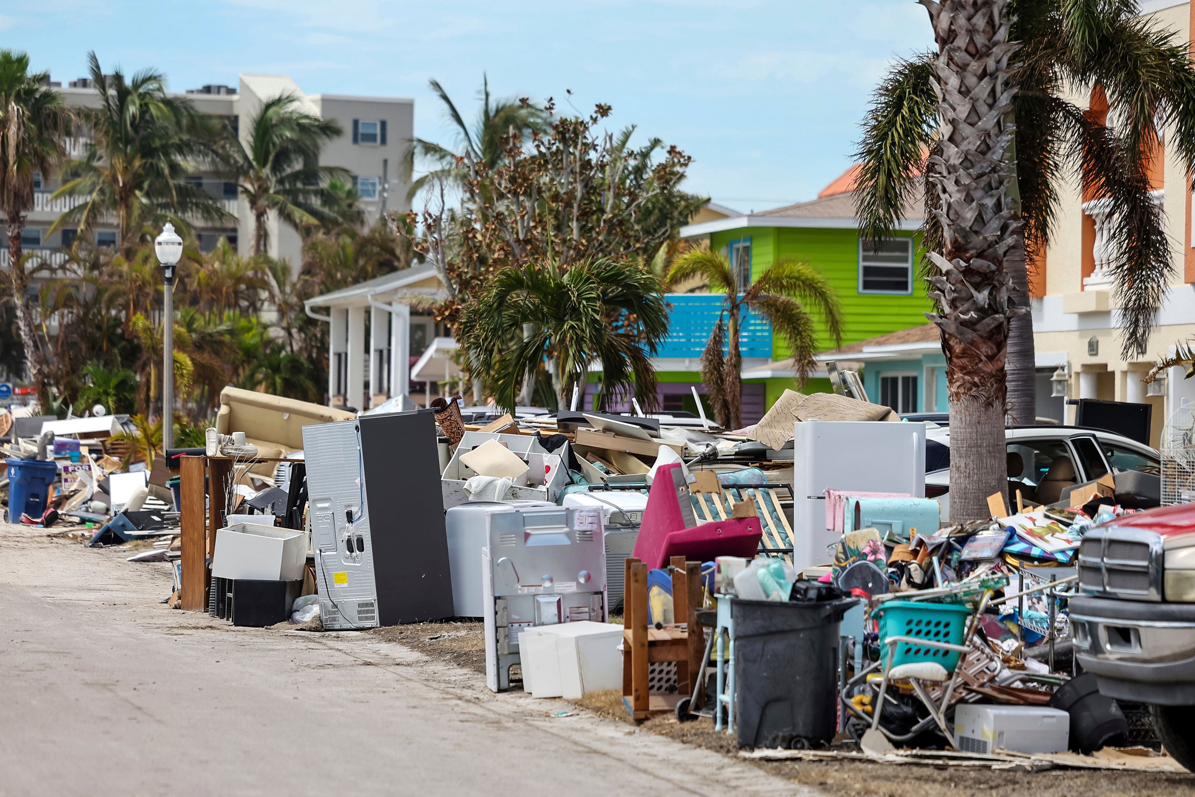 Contents of homes line the streets after flooding from Hurricane Helene on Wednesday, Oct. 2, 2024, in Reddington Shores, Fla. (AP Photo/Mike Carlson)