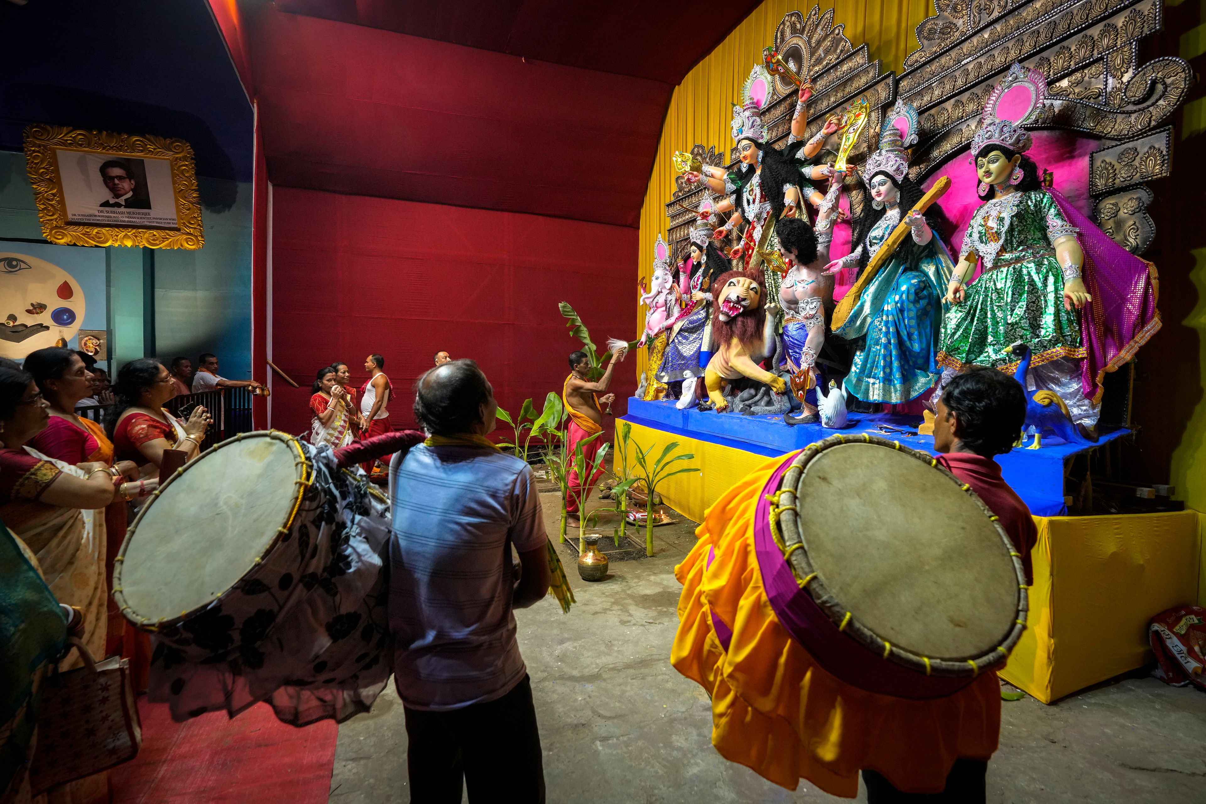 A Hindu priest performs ritual prayers before an idol of the Hindu goddess Durga during the Durga Puja festival in Guwahati, India, Wednesday, Oct. 9, 2024. (AP Photo/Anupam Nath)