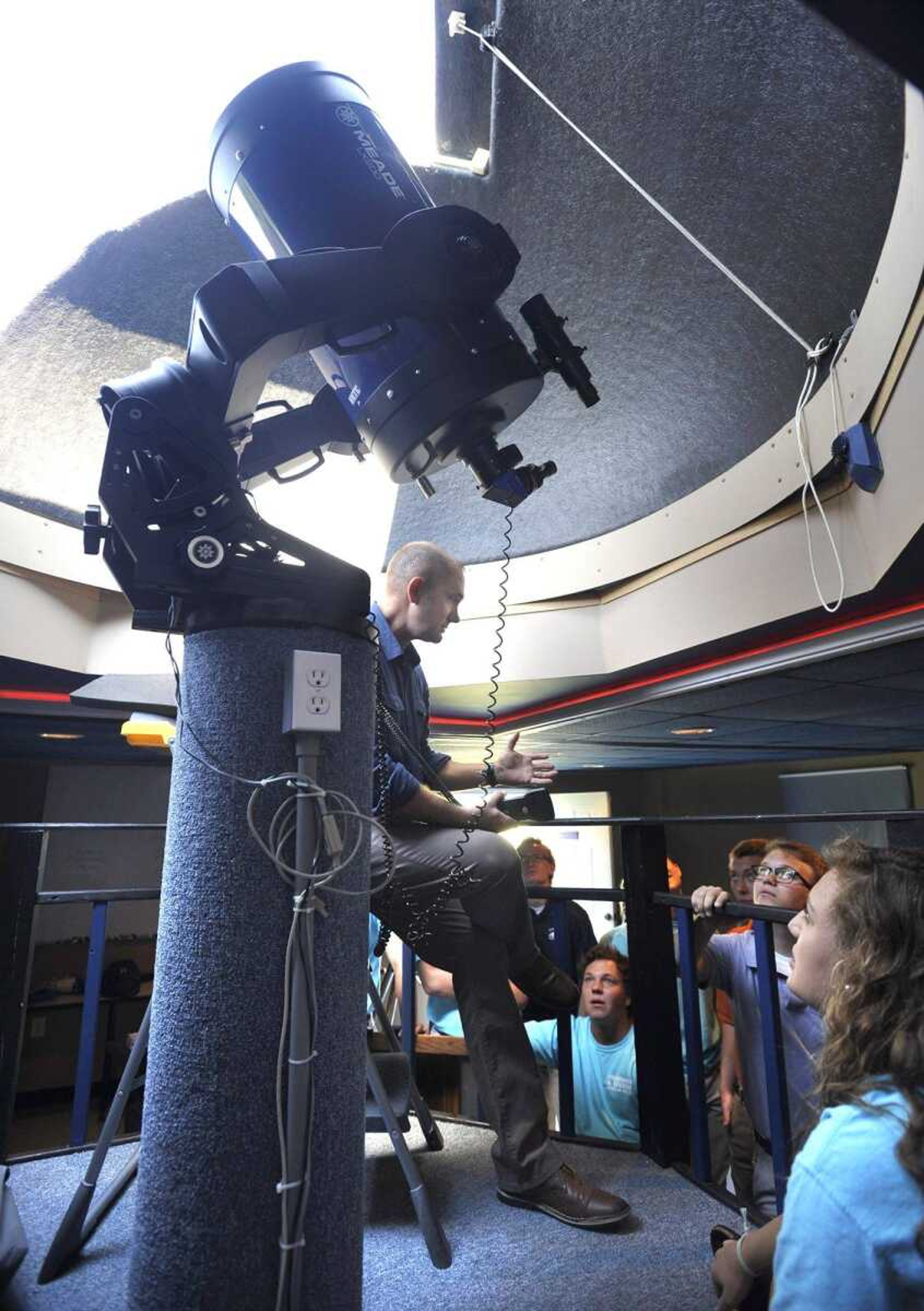 Science teacher Jerry Landewe shows the main telescope to his senior astronomy class Monday in the observatory at Notre Dame Regional High School. (Fred Lynch)