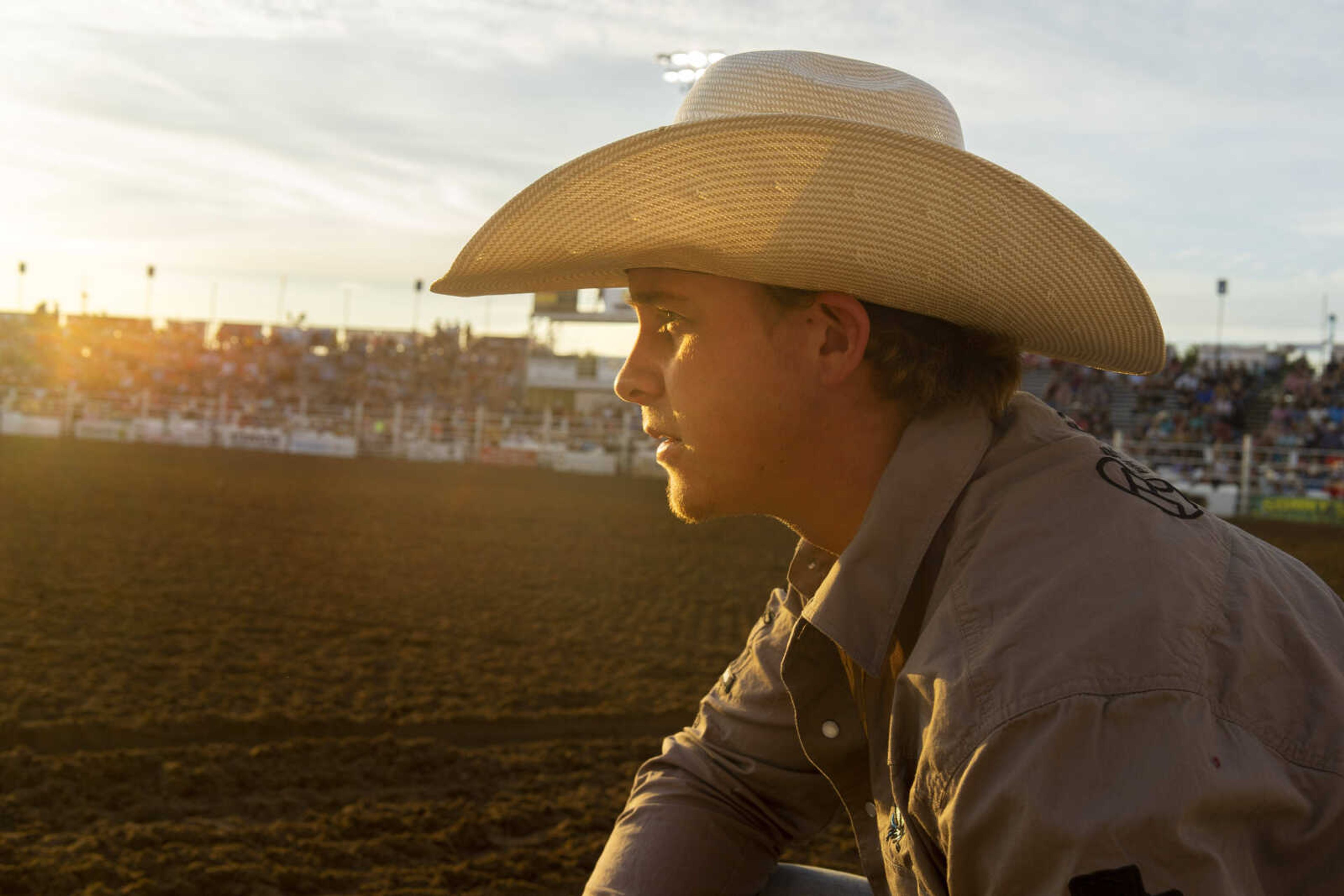 An arena hand watches the gates as a ride begins during the last night of the Sikeston Jaycee Bootheel Rodeo Saturday, Aug. 14, 2021,&nbsp;in Sikeston, Missouri.