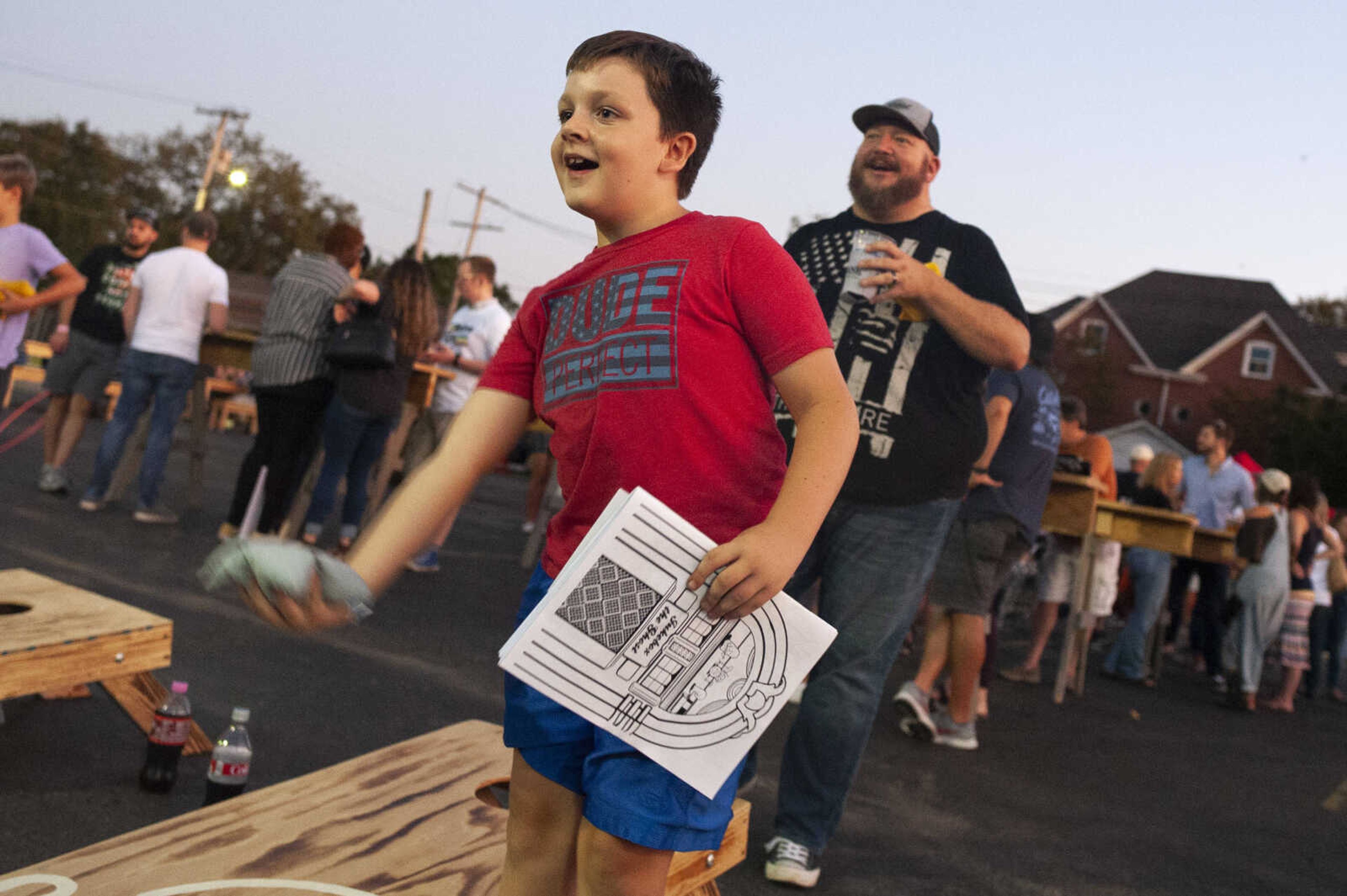 Lawson Burgfeld, 8, of Cape Girardeau, plays bags with his father Darren Burgfeld, in background, during Shipyard Music and Culture Festival on Friday, Sept. 27, 2019, in Cape Girardeau.