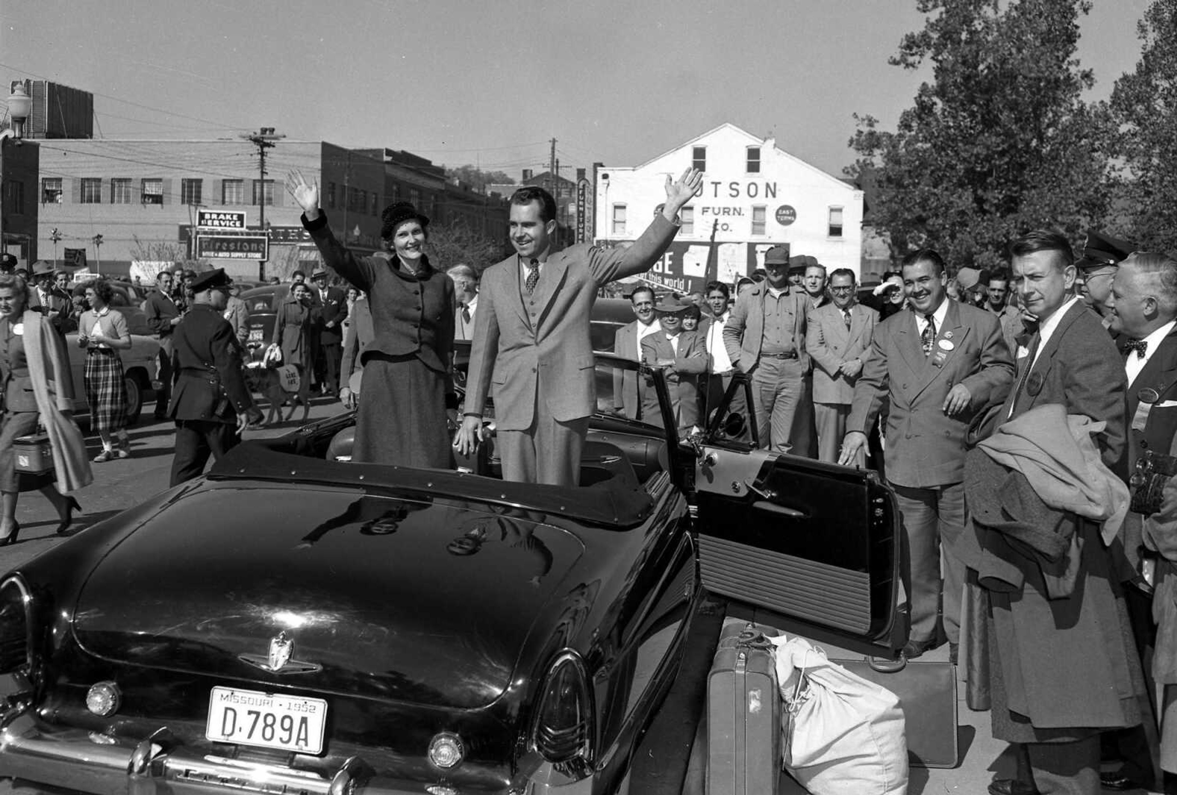 Sen. Richard Nixon and his wife, Pat, wave from the back of a convertible. Sen. Nixon brought his vice-presidential campaign to Cape Girardeau, Mo., on  Oct. 21, 1952. Standing at the open car door is Rush H. Limbaugh Jr., county Republican chairman.
(Photo by G.D. Fronabarger, Cape Girardeau Southeast Missourian)