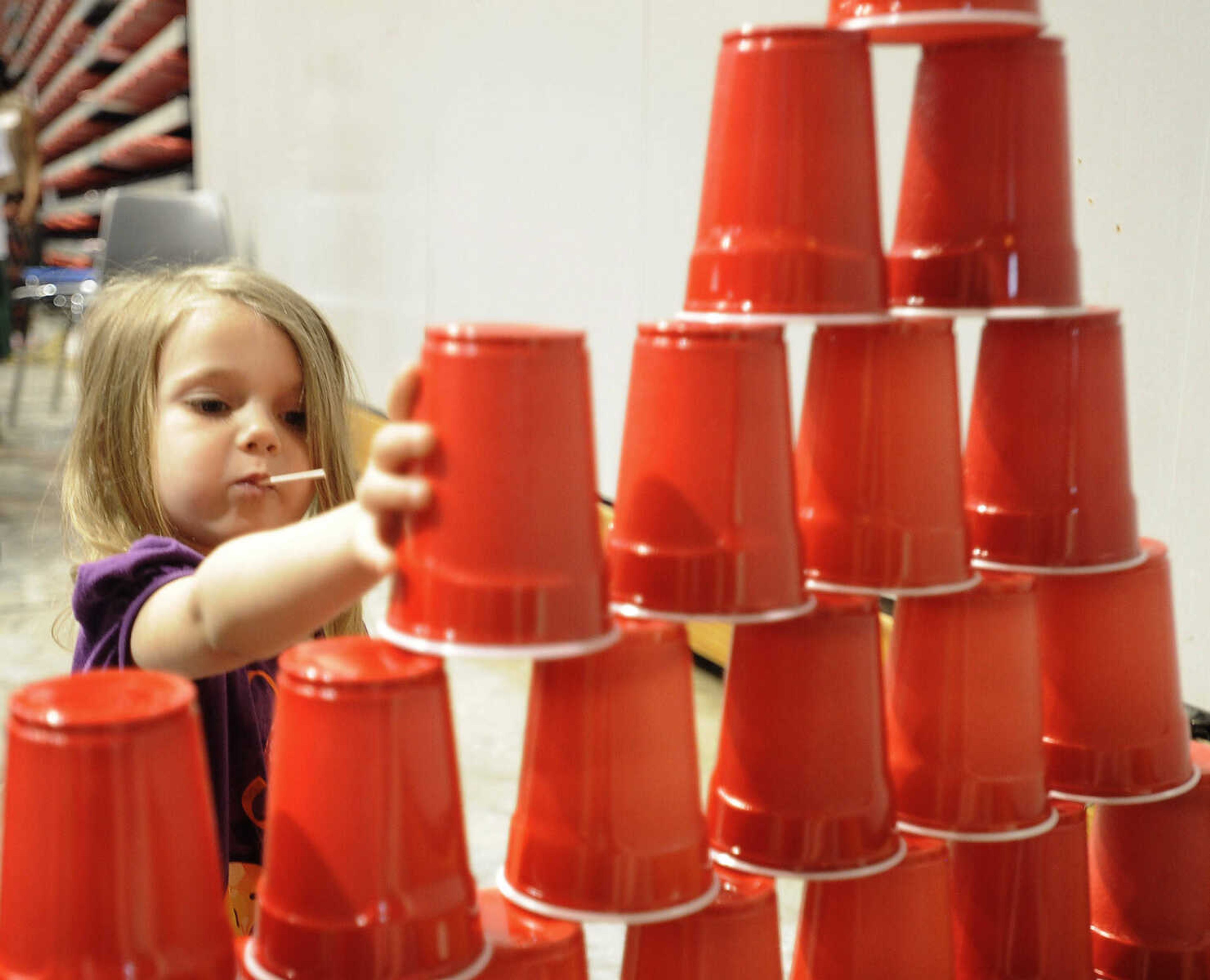 Alexis Thomas of Oran, Missouri stacks plastic cups at the Messy Morning event Saturday, April 25, 2015 at the Show Me Center.