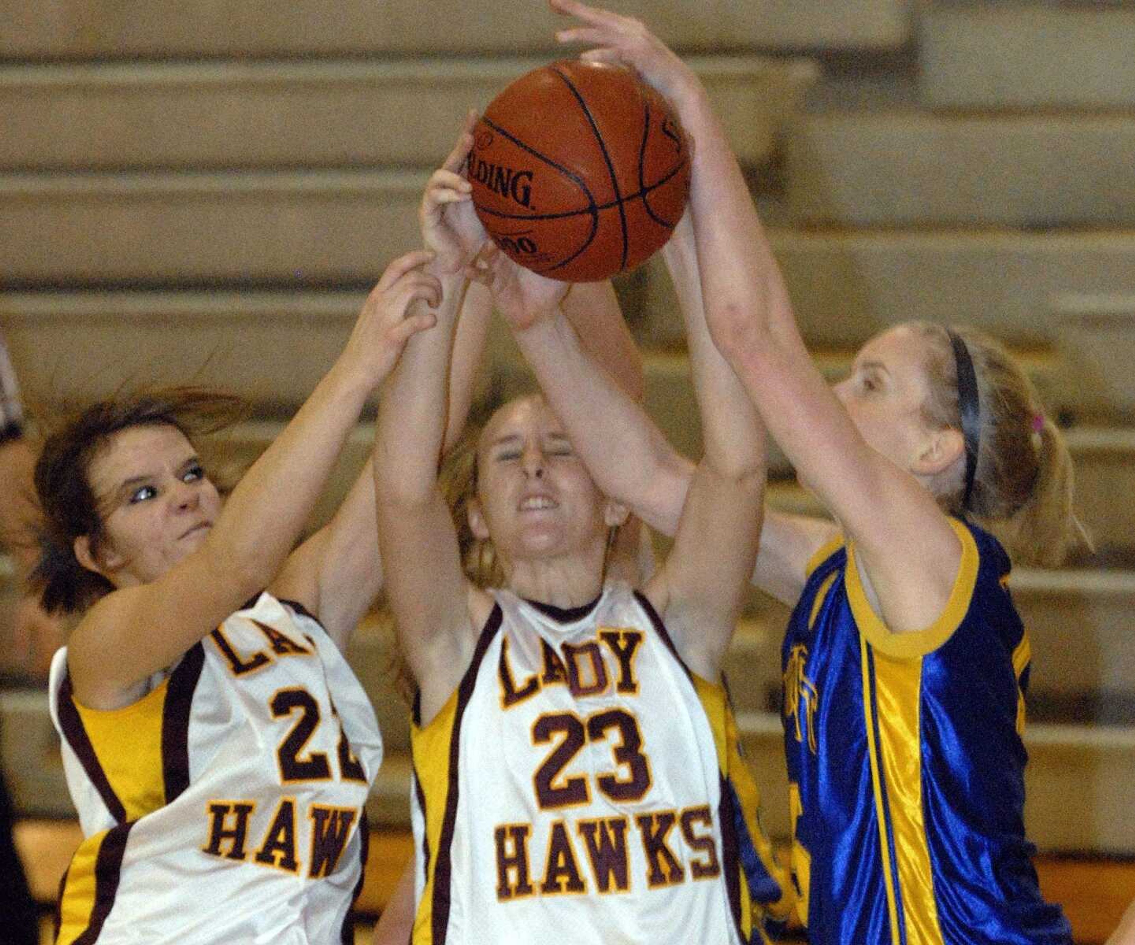 FRED LYNCH ~ flynch@semissourian.com
Kelly's Lana Whitworth, left, and Tara Johnson battle St. Vincent's Amanda Wengert for a rebound in the first quarter Monday at Kelly High School.