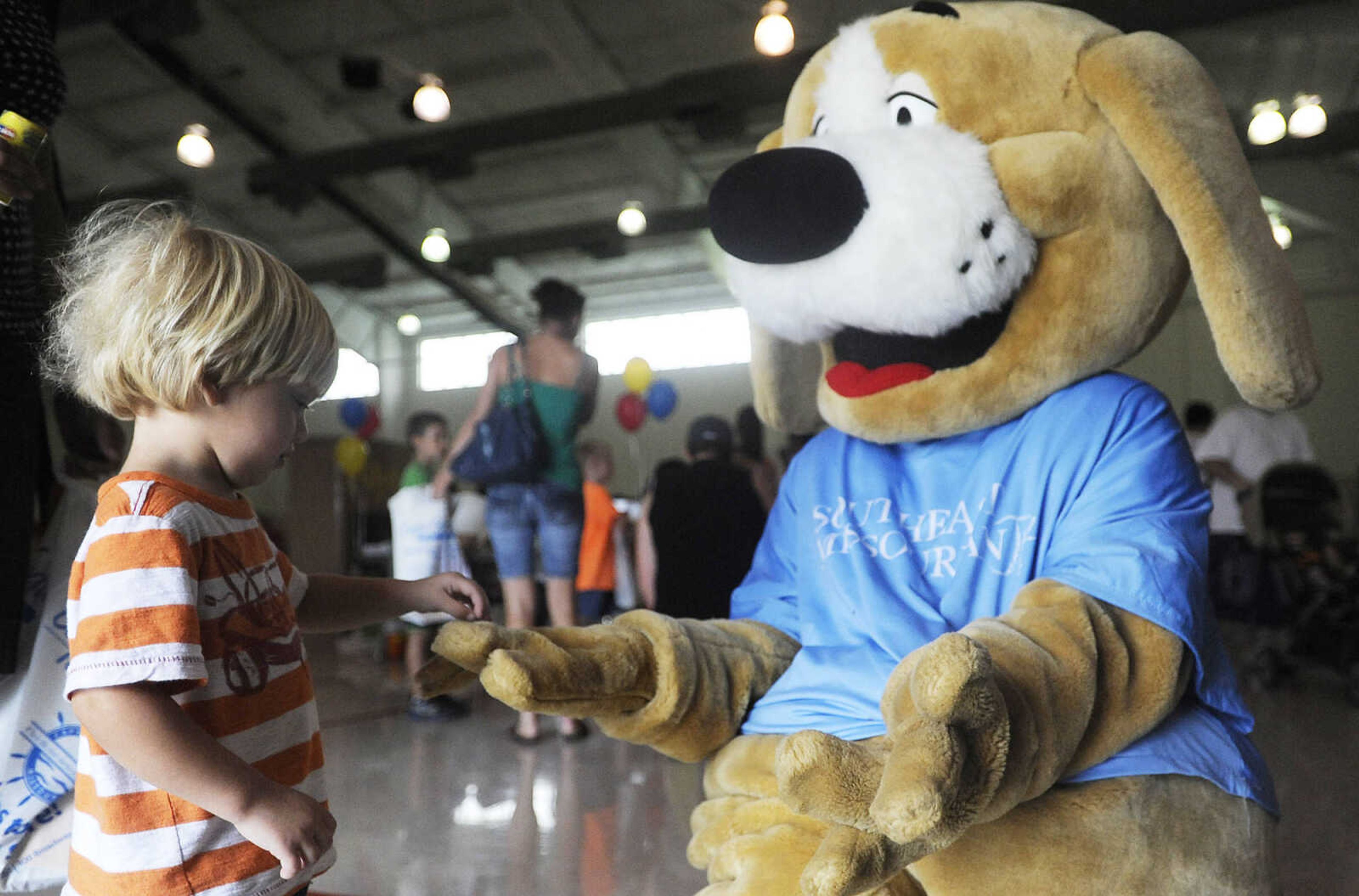 ADAM VOGLER ~ avogler@semissourian.com
Aiden McLean, 2, gives Tracker five during the 11th annual Cape Girardeau Parks and Rec Day Friday, July 13, at the Osage Center.