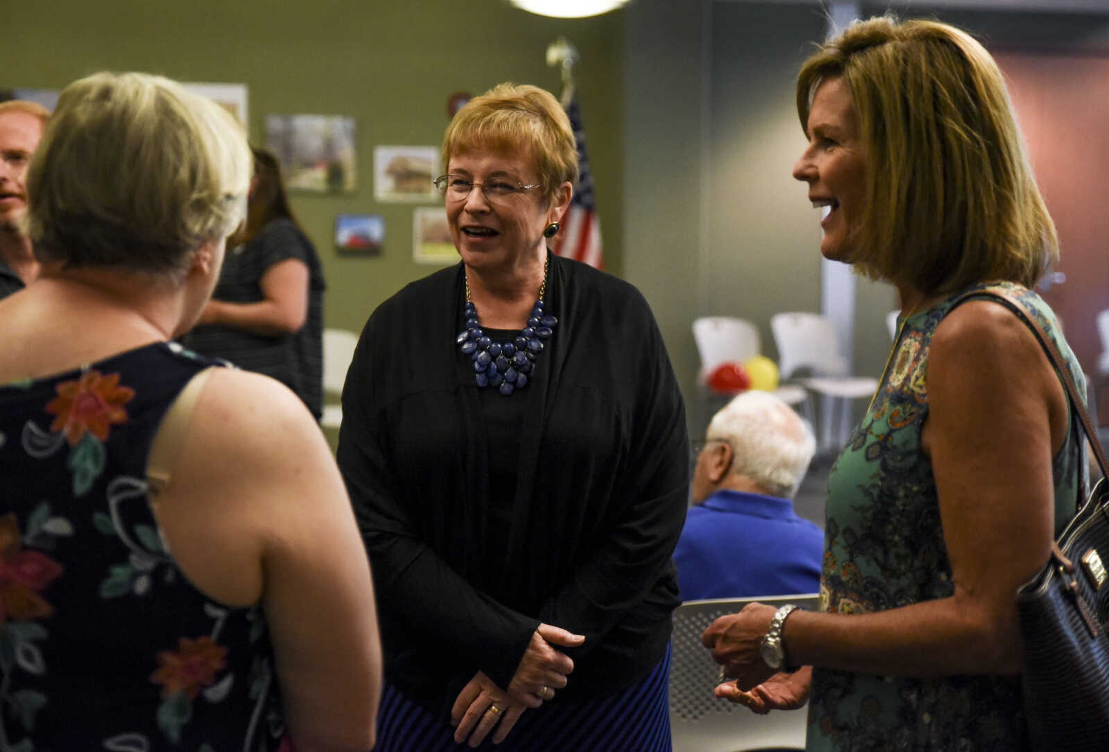 Betty Martin, center, converses at her retirement open house Friday, July 13, 2018 at the Cape Girardeau Public Library.