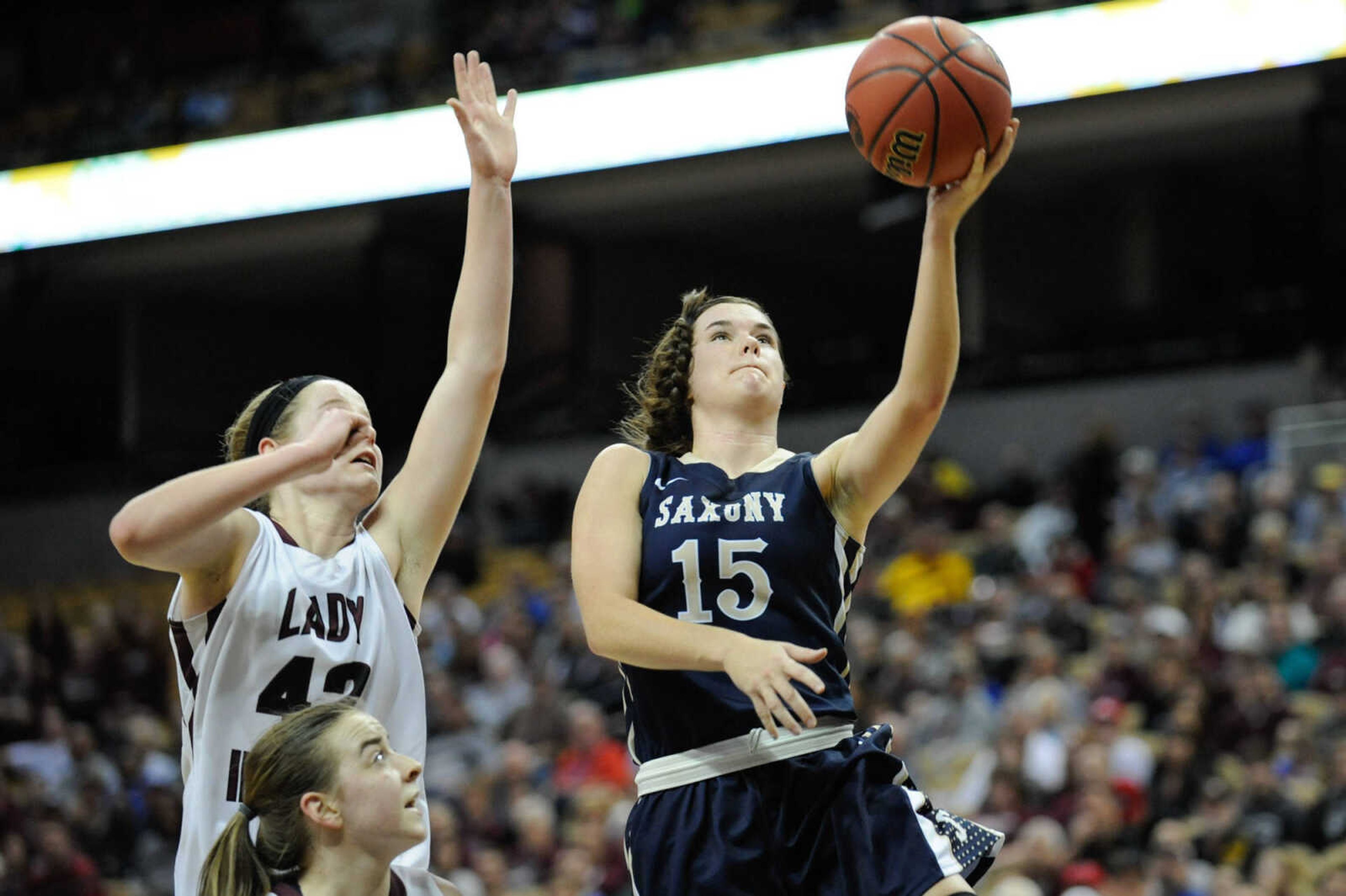 Saxony Lutheran guard Brianna Mueller slips past Strafford forward Hayley Frank for a layup during the Class 3 state championship on Friday at Mizzou Arena in Columbia, Missouri.