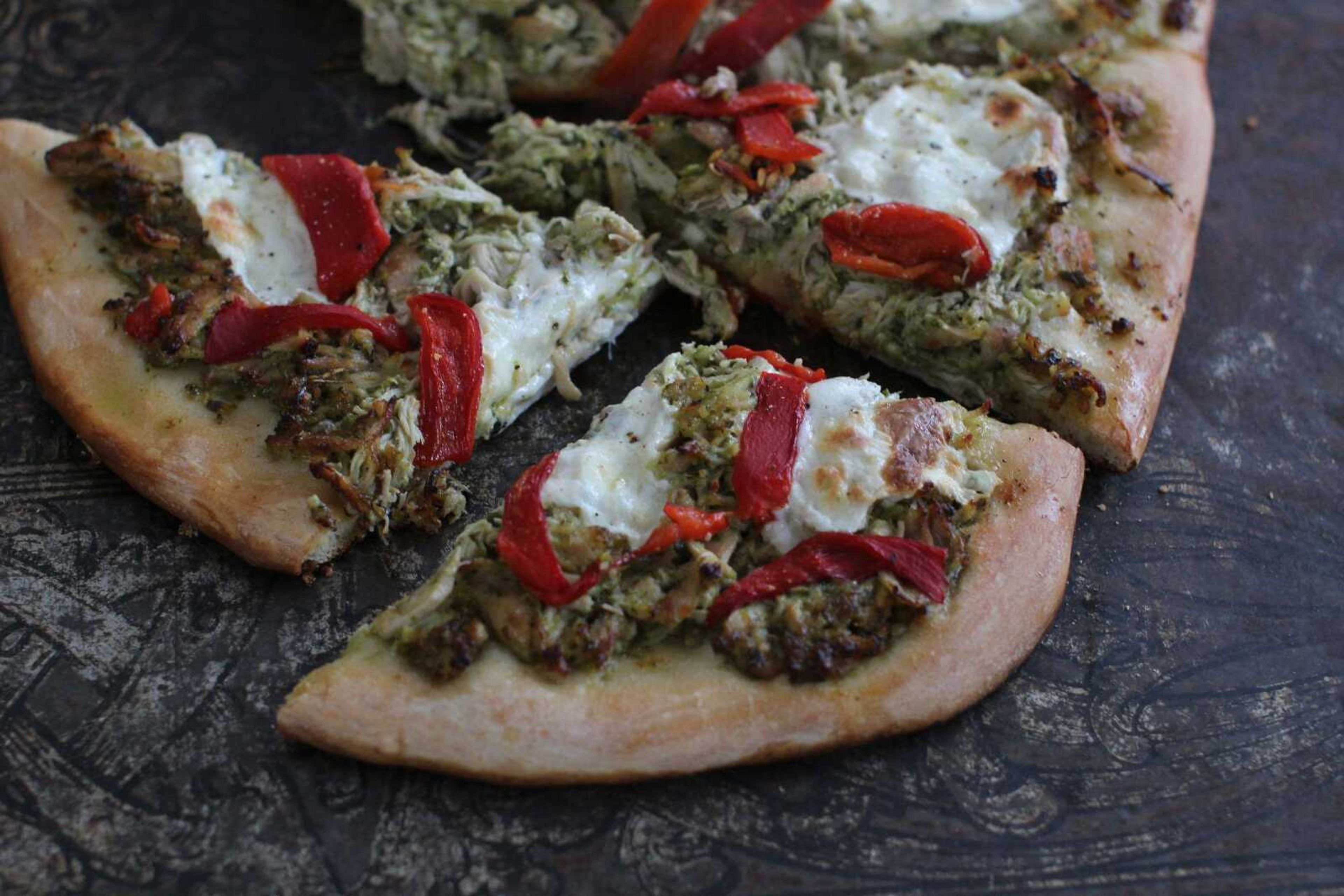 Cutline-File Credit:ABOVE: This Jan. 19 photo shows slow-cooker pulled-chicken pesto pizza in Concord, New Hampshire. BELOW: Slow-cooker pulled-chicken Greek pitas. (Cutline-File Credit:Matthew Mead  ~ Associated Press)