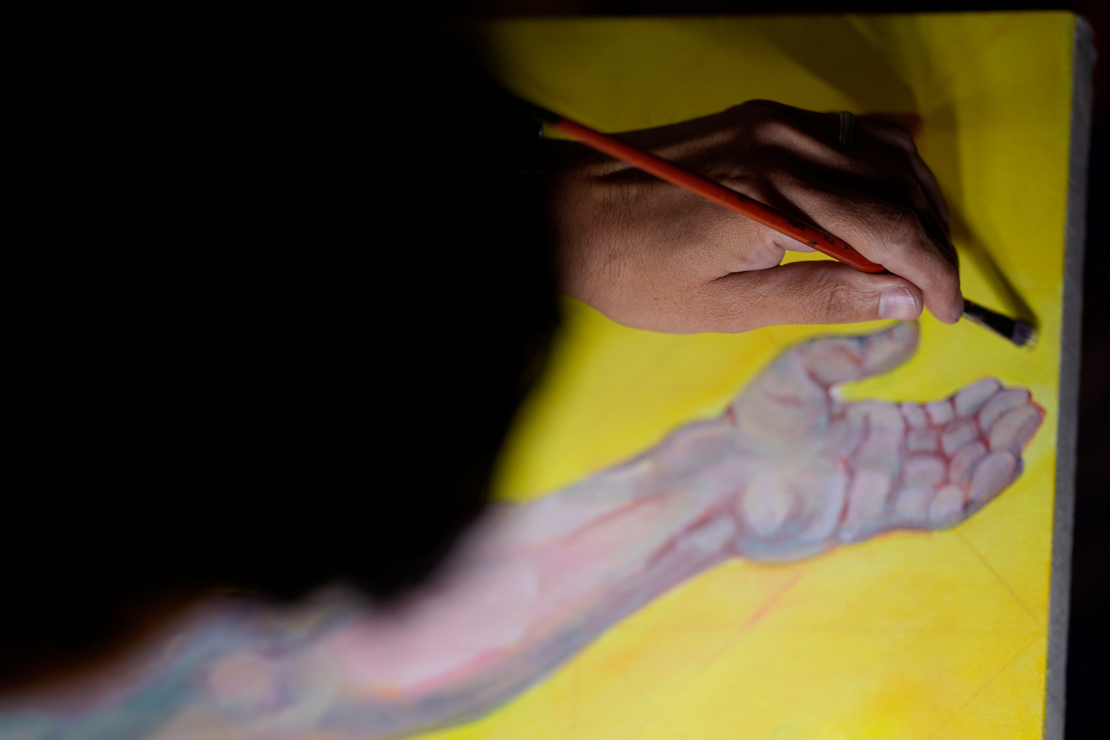 Artist David Alcantar works on an art piece for his "Superman Project" that in part encourages people to exercise their right to vote in San Antonio, Thursday, Sept. 19, 2024. (AP Photo/Eric Gay)