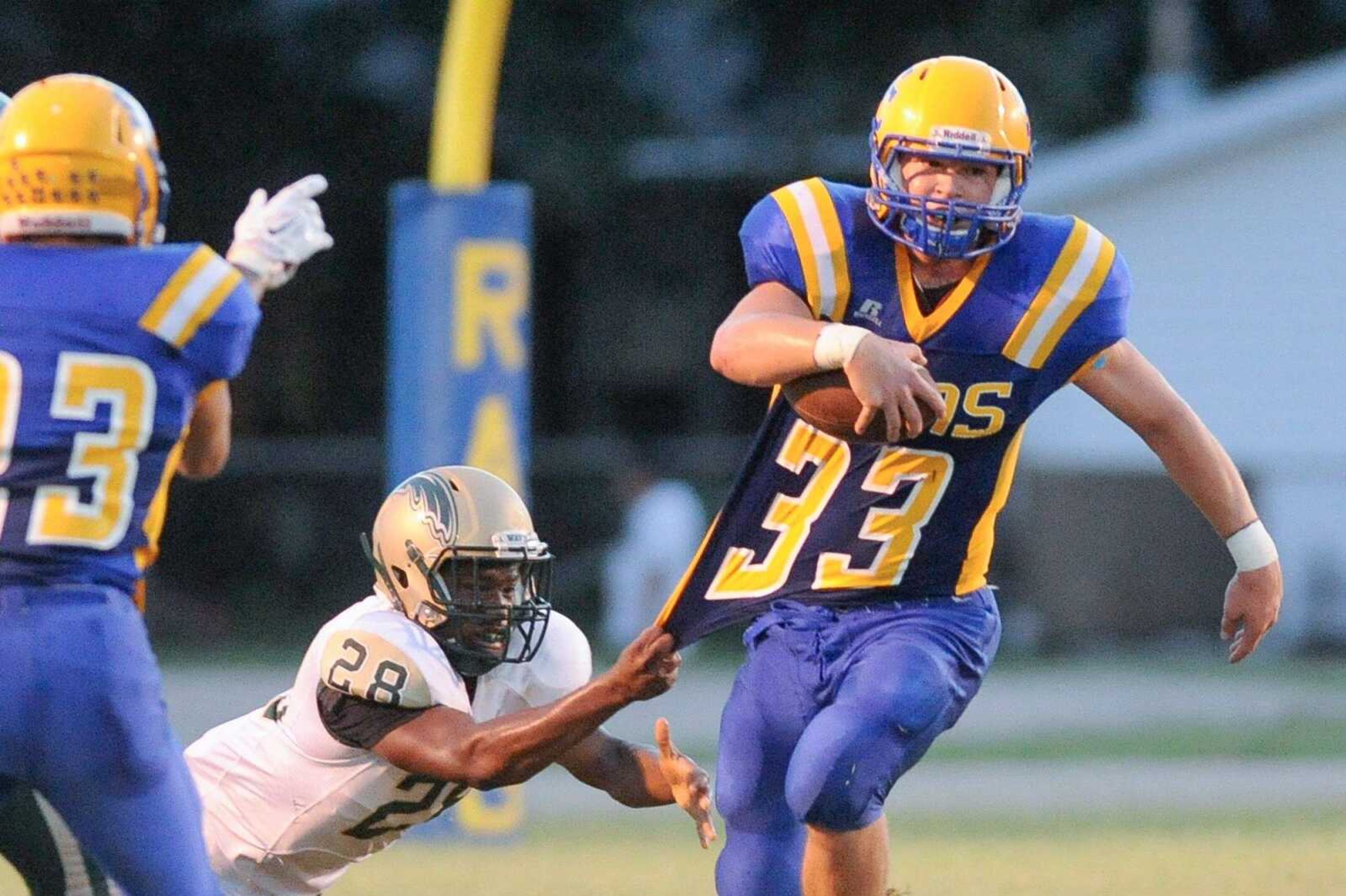 Scott City's Braden Cox is brought down by Malden's Tray Stevenson on a run in the first quarter Friday, Sept. 11, 2015 in Scott City. (Glenn Landberg)